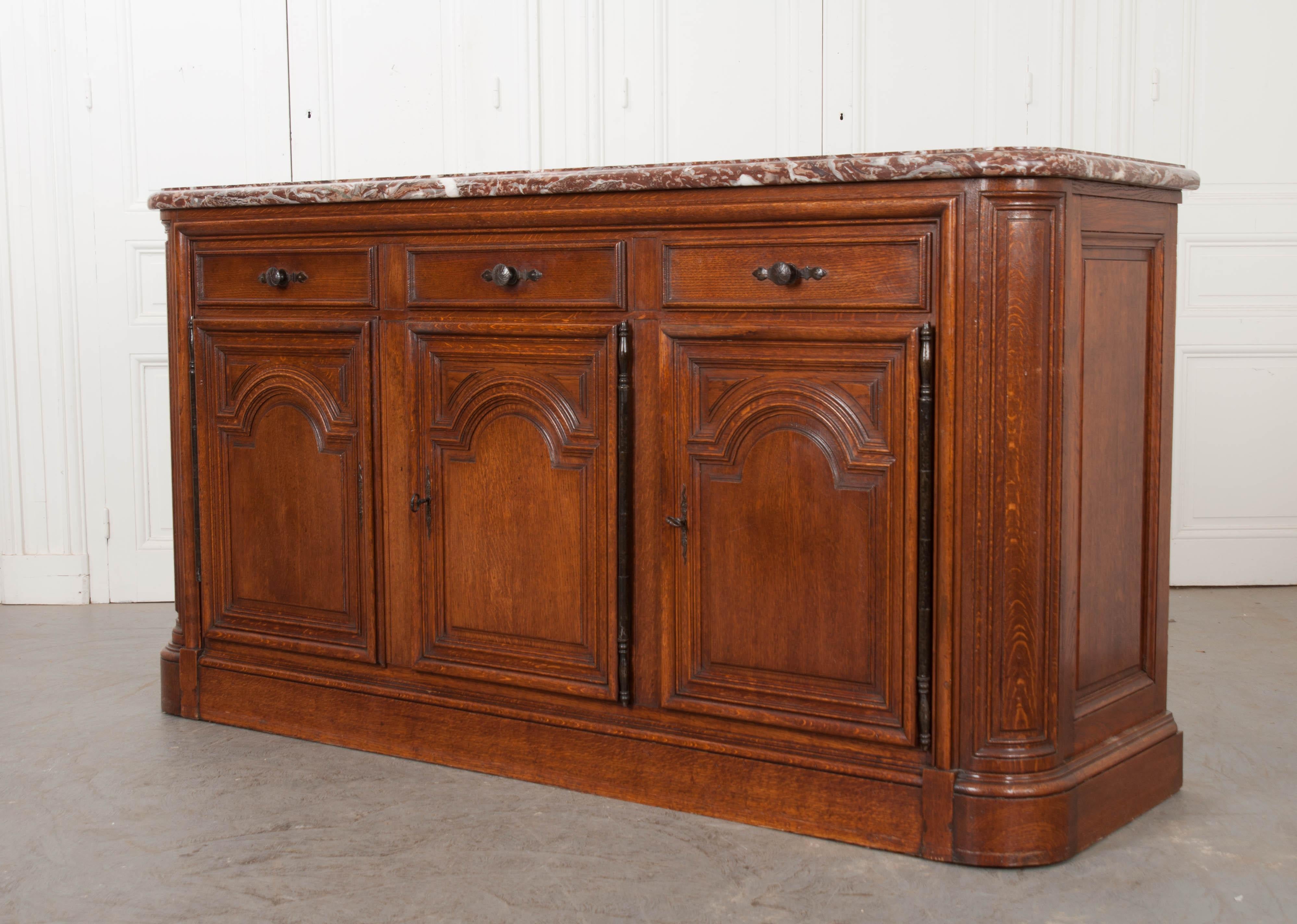 This beautifully carved and constructed English vintage oak buffet has a thick 1-3/4