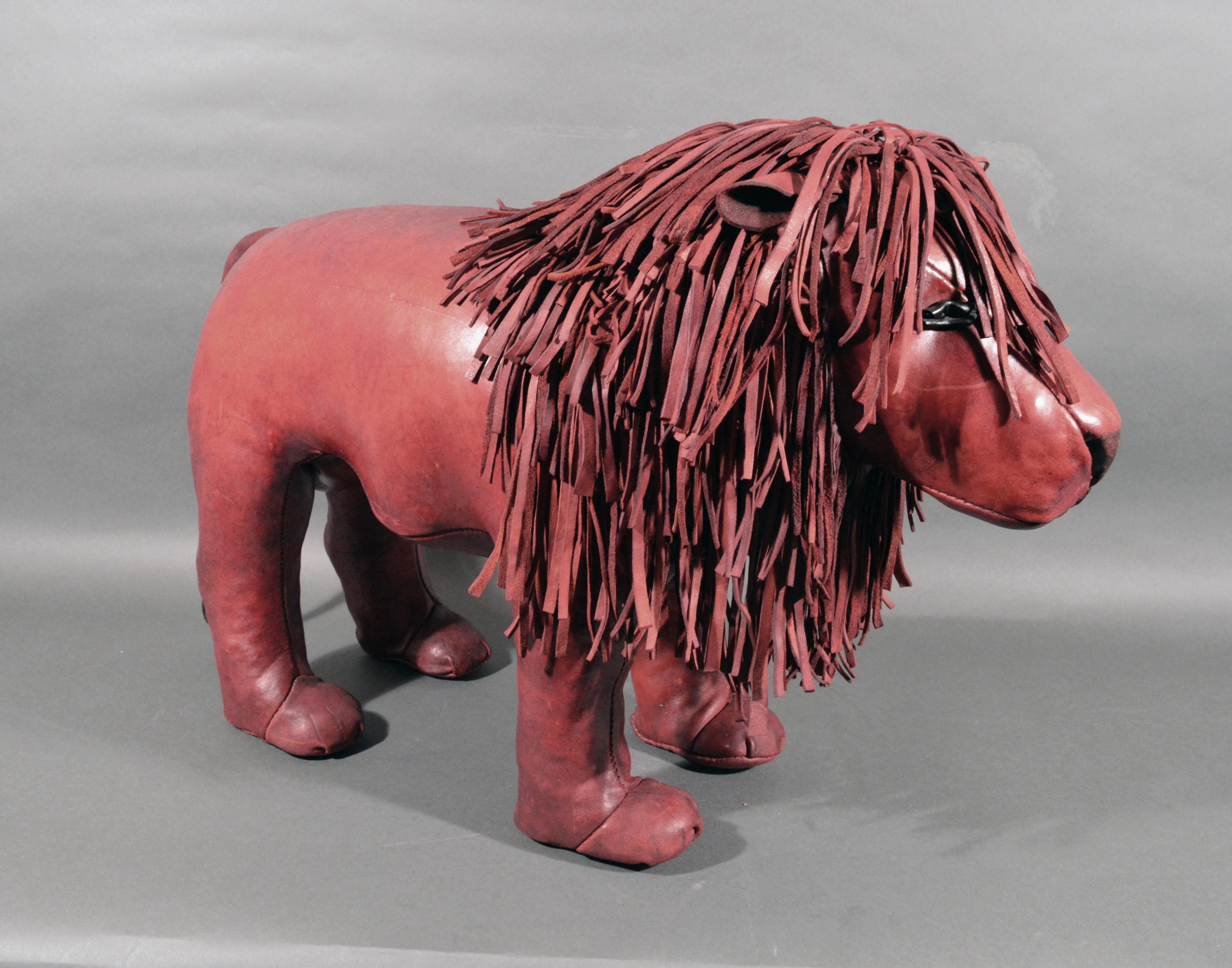 English vintage large leather golden lion foot stool,
Dimitri Omersa, England,
1974-1980s.

Dimensions: 20 inches high x 29-1/2 inches wide

From the Omersa website:

The golden lion was first introduced in the 1960s. In those days it had