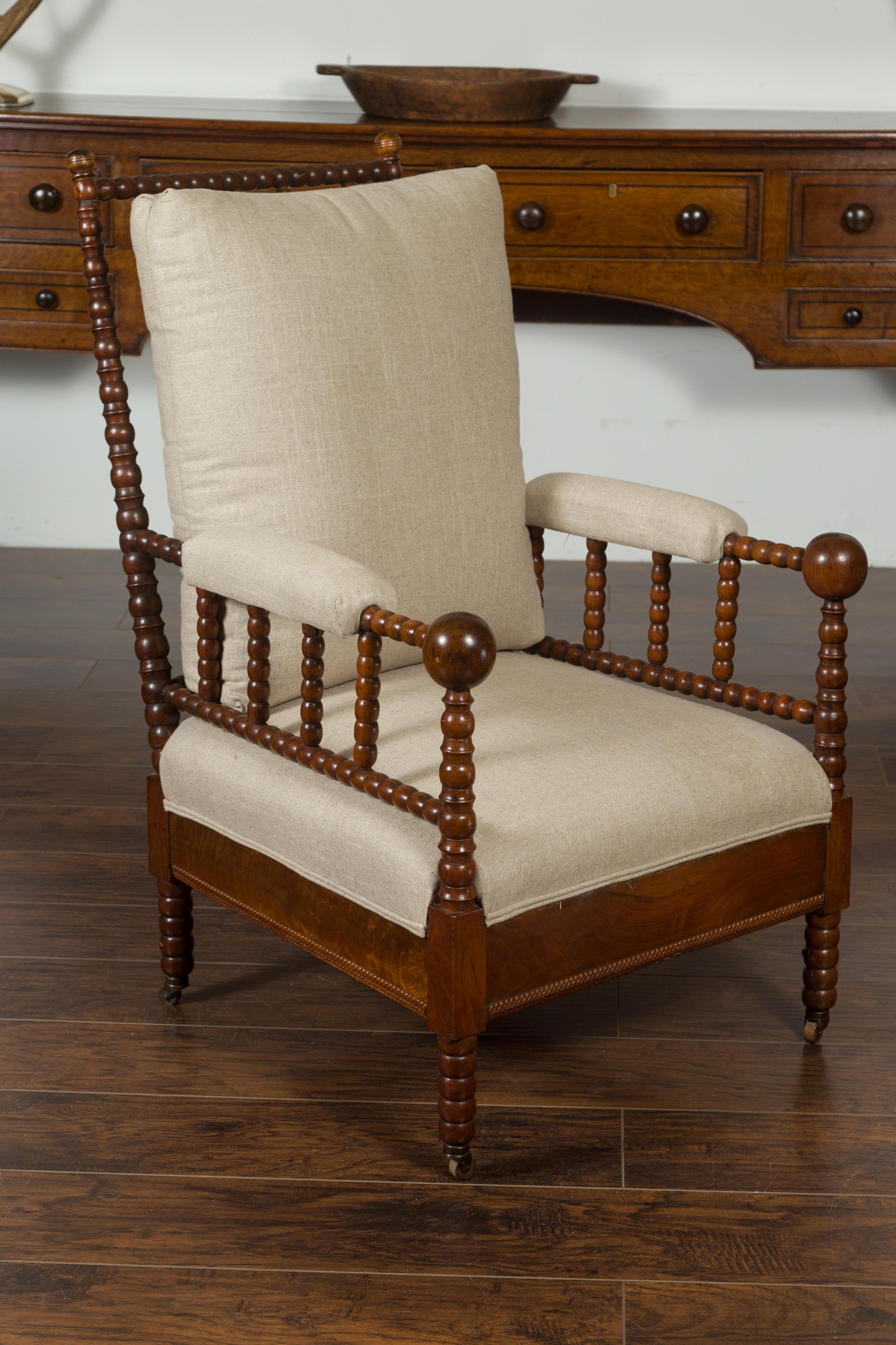 20th Century English Walnut Bobbin Armchair with New Upholstery and Casters, circa 1920