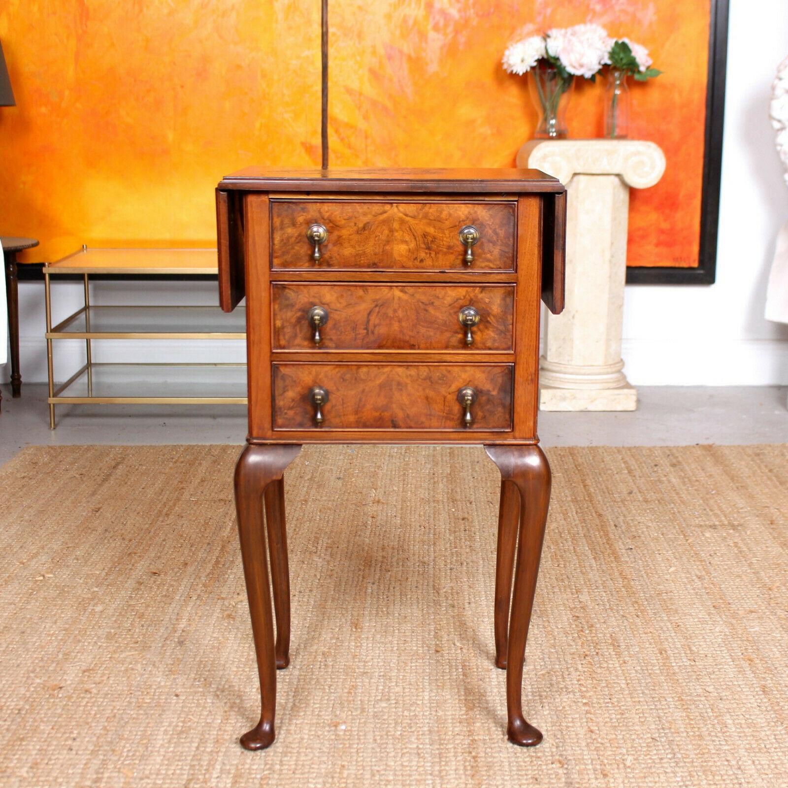 The walnut marquetry work boasting a well figured burl grain.
The top with chamfered egdes extending by way of drop leafs. Fitted three graduated drawers with dovetailed jointing, solid interiors and mounted with good teardrop handles. Raised on