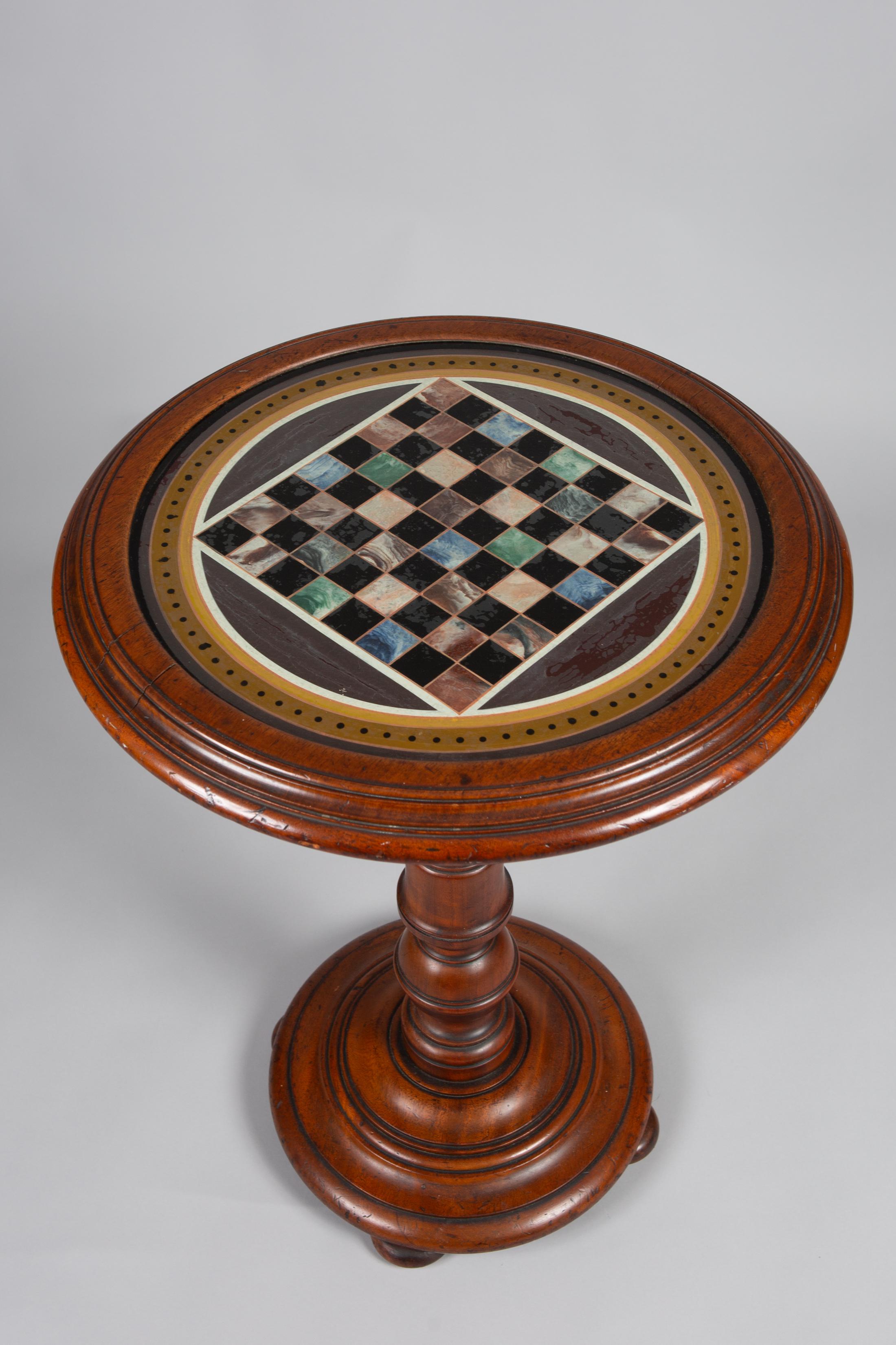 English walnut games table, pedestal style small table with games board underneath a glass top.