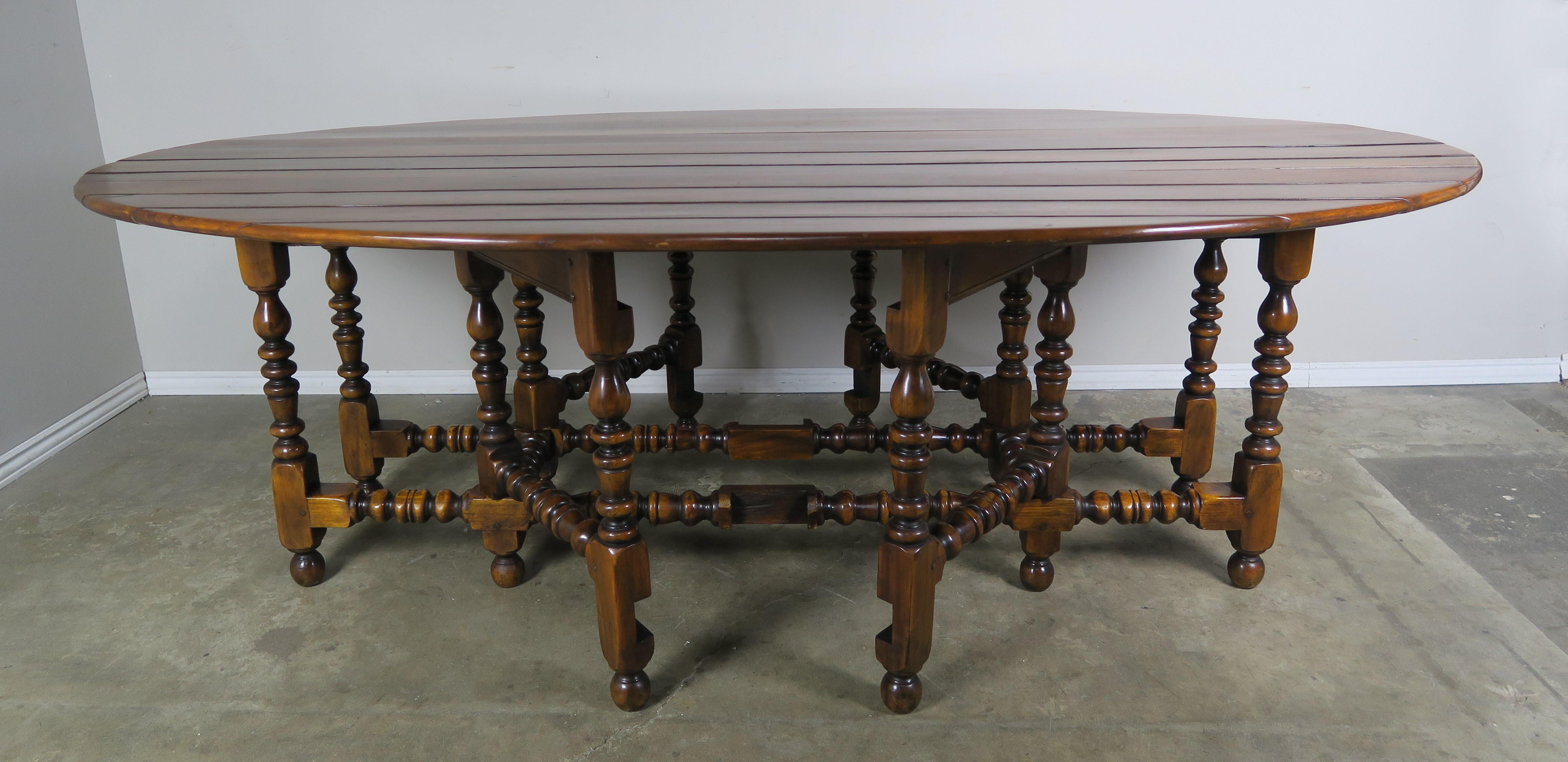 Mid-20th century English walnut gate-leg drop-leaf table with beautifully turned legs. The large dining table can be dropped down to only 19.5