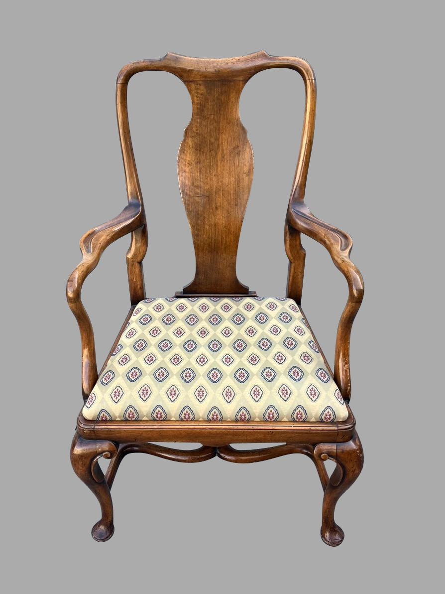 A nicely scaled English walnut open armchair in the George II style with an upholstered drop in seat. This attractive and commodious chair sits well and is quite comfortable. The shepherd's crook arms have a lovely incised detail and the cabriole
