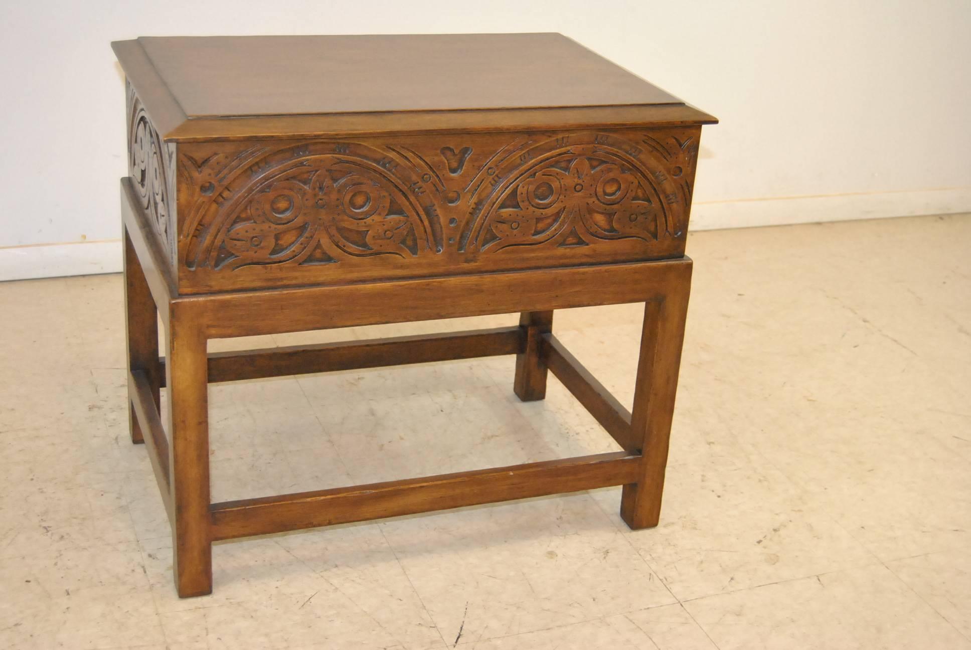 A beautiful English lift top or bible box by Minton-Spidell, #4818. A finely carved walnut lift top box that sits upon a dark stained oak stand. Nice hand wrought hardware. The dimensions are 25.5