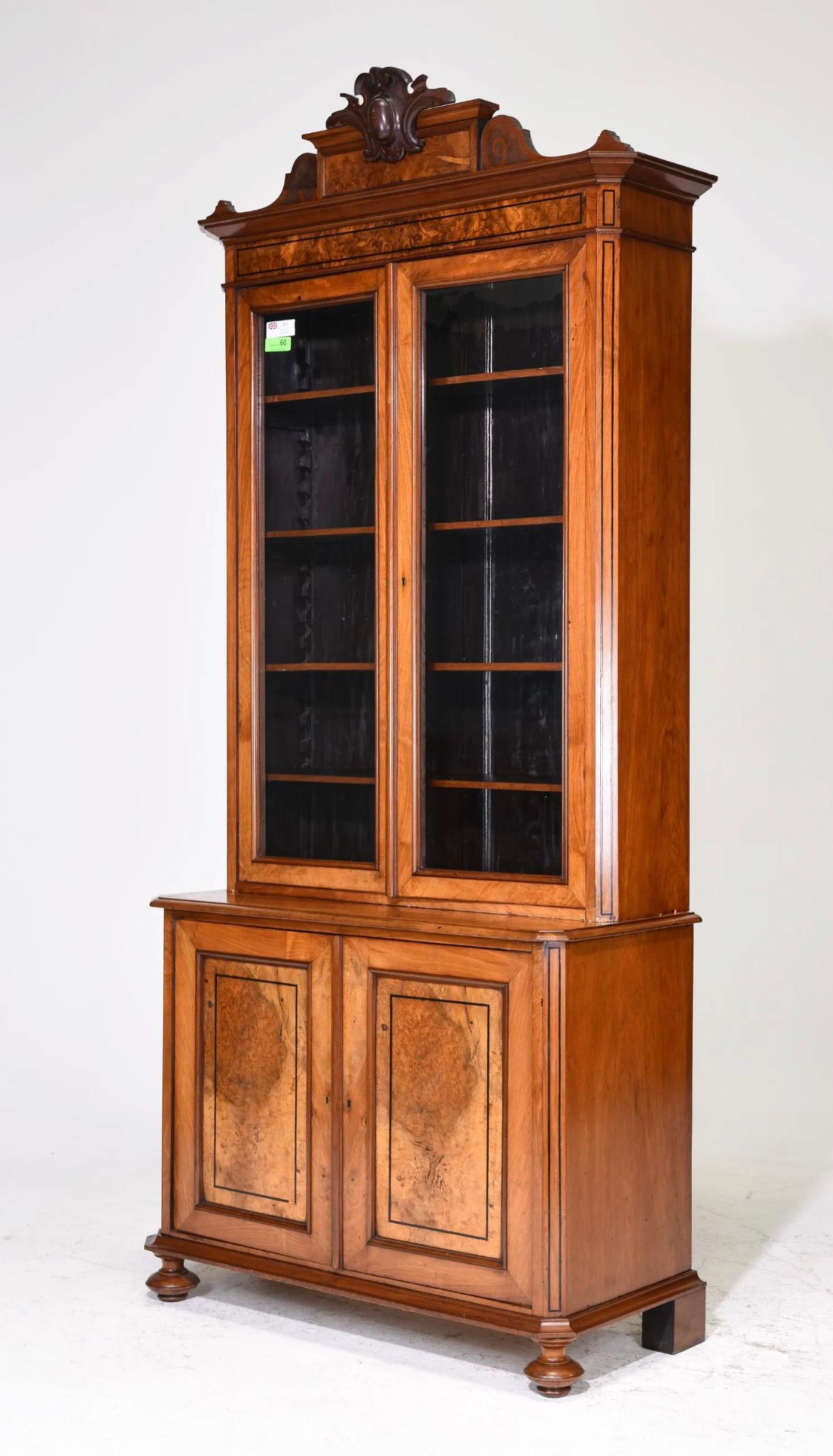 Beautiful English Walnut Stepback Bookcase / Cupboard. Burled door details with in-set detail at doors, carved crown with crest-like detail, original glass in upper doors, chamfered corner detail. 

90.5 in tall x 40 x 18, Shelf depth in top cabinet