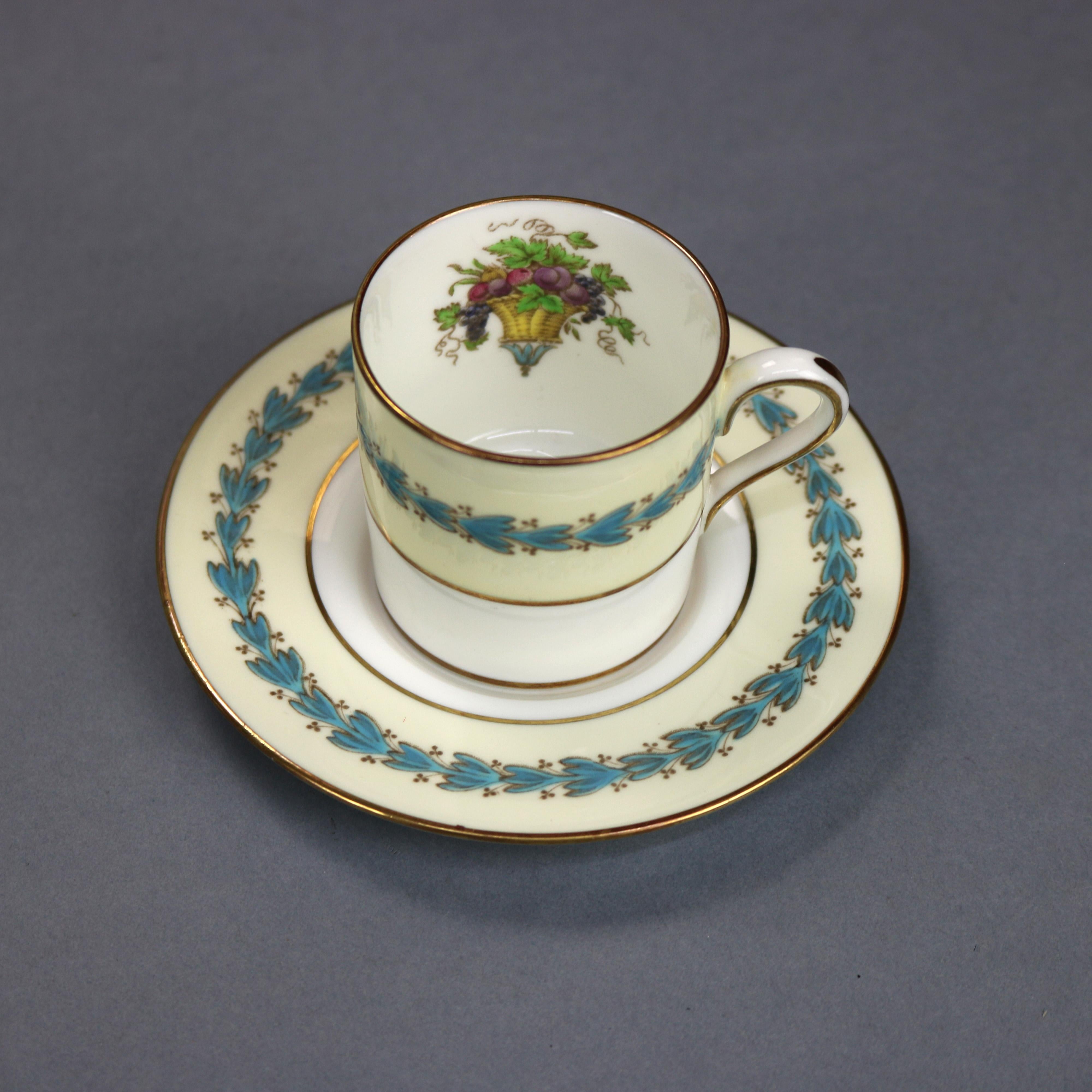 A set of Wedgwood Appledore fine bone china bouillon, demitasse and coffee/tea cups with saucers offer central fruit basket with laurel wreath border, rim with inverted bellflowers, gilt highlights throughout, en verso maker mark as photographed,