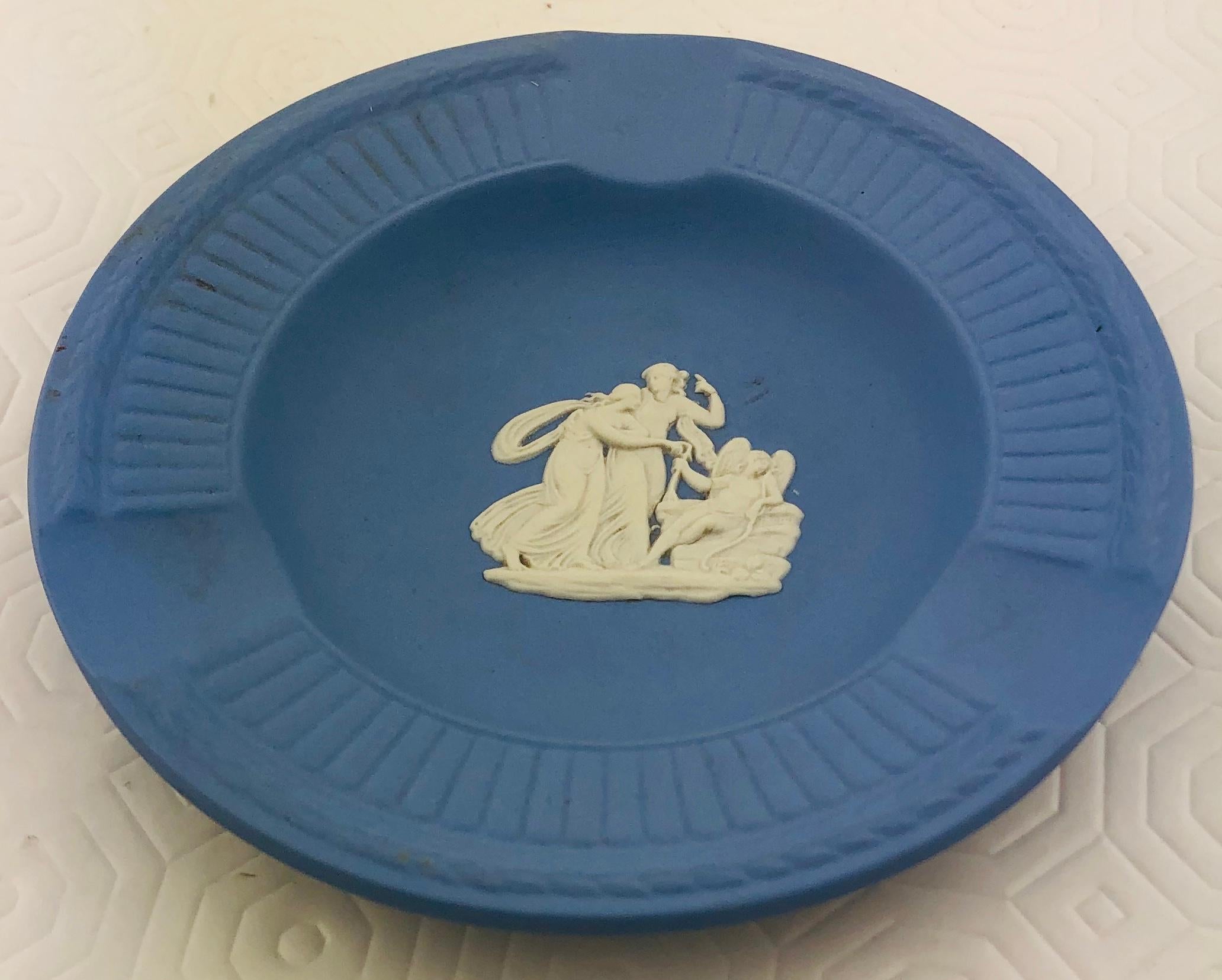 Beautiful English Wedgwood Jasperware ashtray or key holder/vide poche in “Wedgwood Blue” features a repeating motif of white, high relief acanthus leaves alternating with floral sprigs and a floral banded border.

Jasperware or jasper ware is a