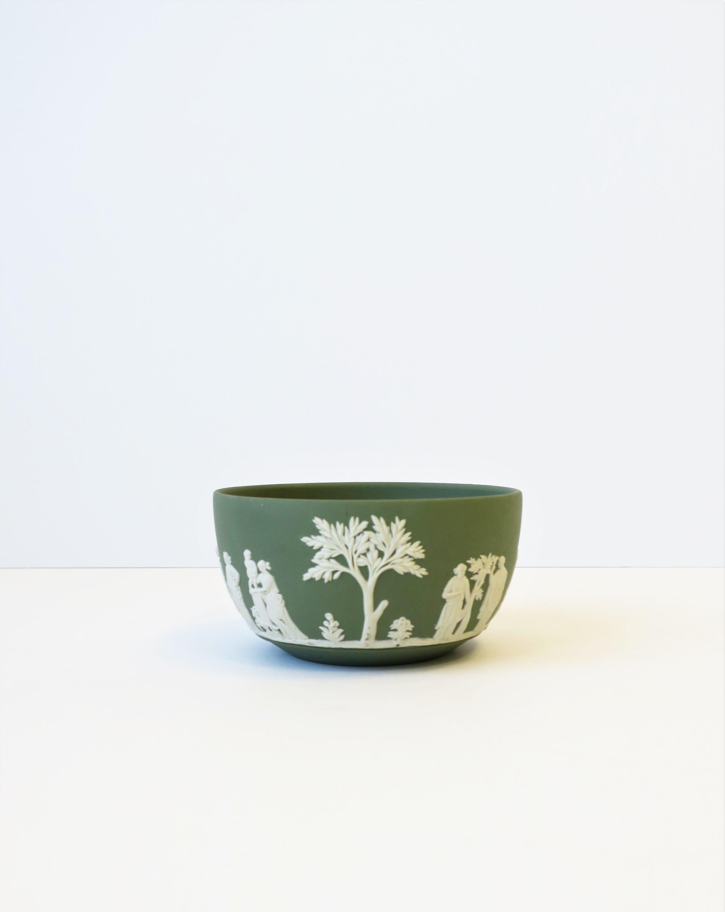 A beautiful English Wedgwood Jasperware sage green and white matte stoneware bowl, in the Neoclassical design style, circa mid- to late 20th century, England, 1973. Piece is a matte stoneware in a light green with a white neoclassical raised relief