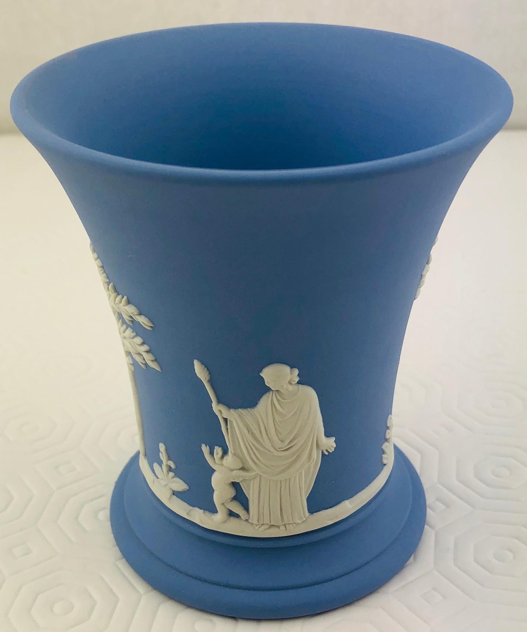 Beautiful English Wedgwood Jasperware cup or pencil holder in “Wedgwood Blue” features a repeating motif of white, high relief acanthus leaves alternating with floral sprigs and a floral banded border.

Jasperware or Jasper ware is a type of