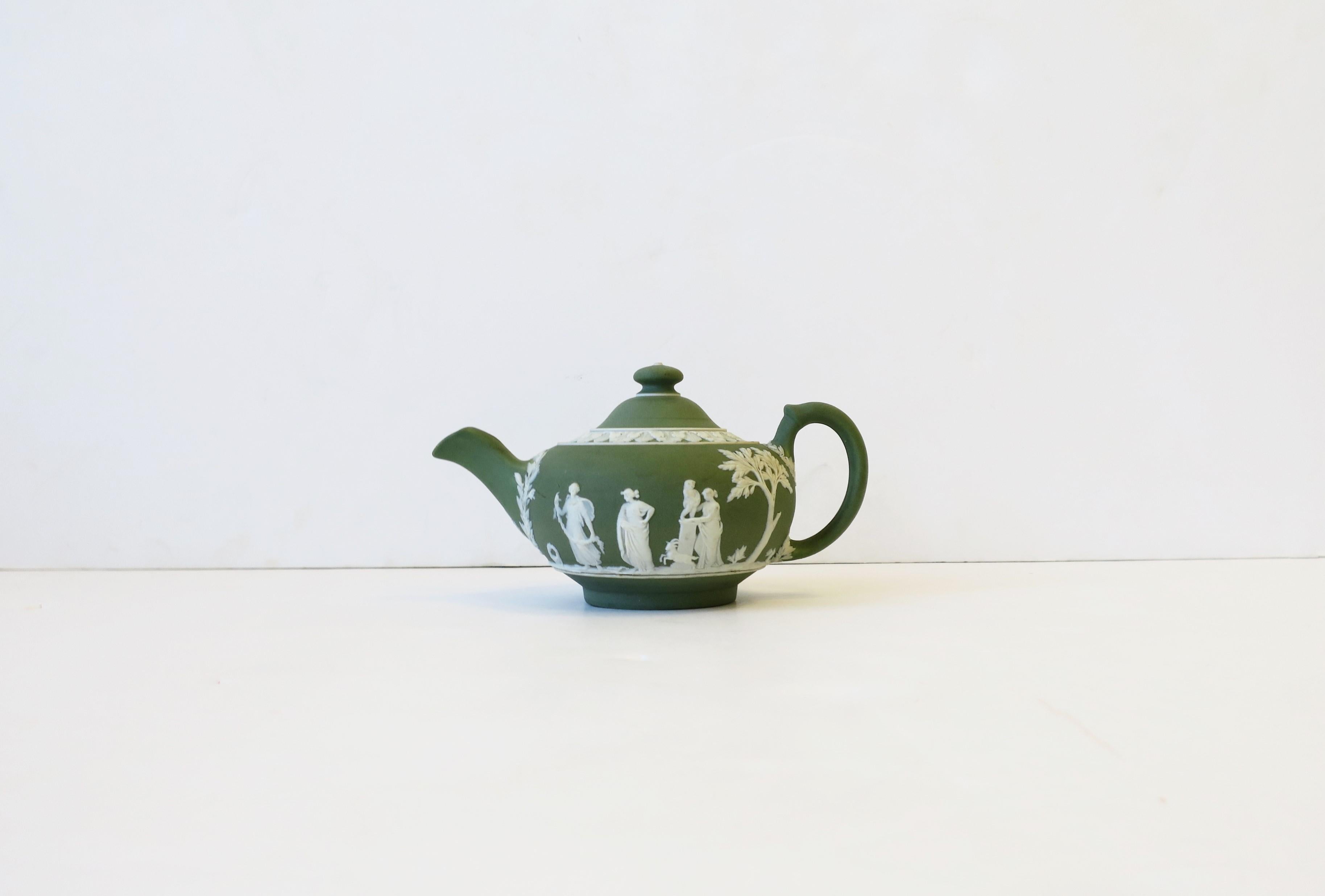 A beautiful English Wedgwood Jasperware matte green and white stoneware coffee or tea pot with neoclassical design, circa turn of the century-early 20th century, England. Piece is matte stoneware in a light green with a white neoclassical raised