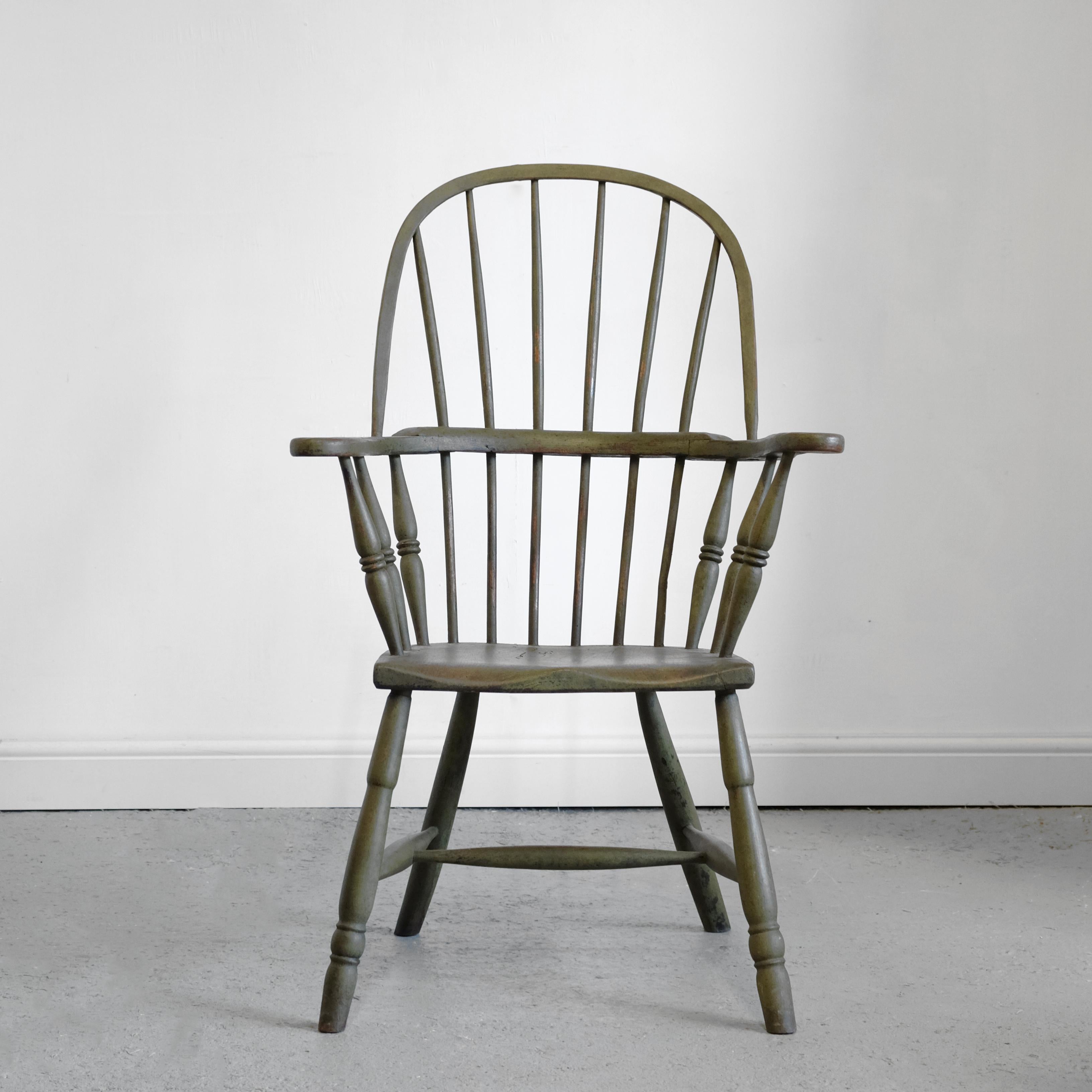 A good West Country stick and hoop back Windsor armchair in later green paint. Attributed to Cornwall, it is of a more unusual design than normal, having six decoratively turned arm supports, as opposed to two or four. Egg and reel front legs and
