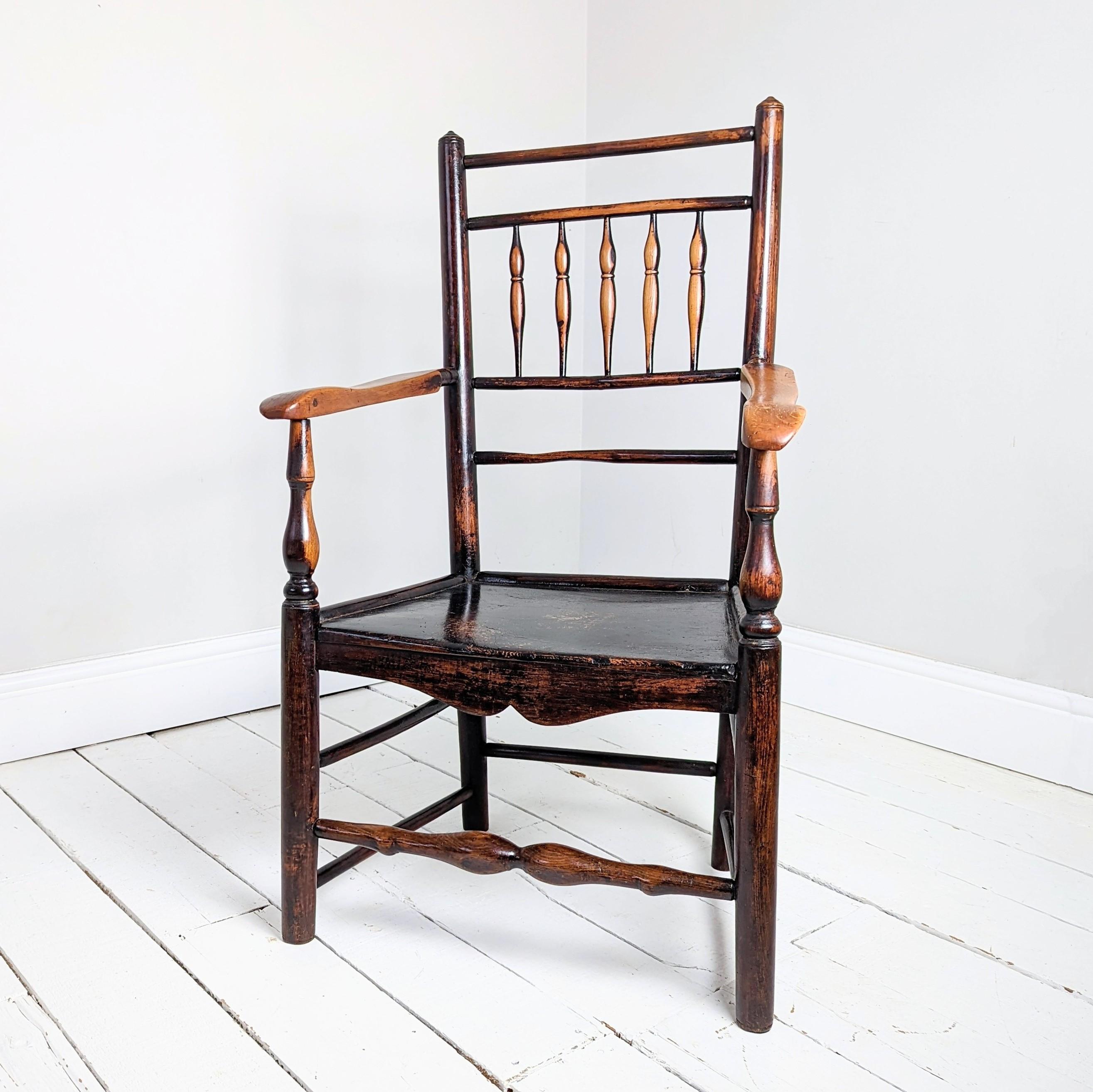 A West Midlands spindle-back armchair in ash, elm and beech. 

Stylistically similar to the well known Clisset, Kerry & Warrender chairs, however the arms, spindles and finials indicate a maker outside these families within the counties of