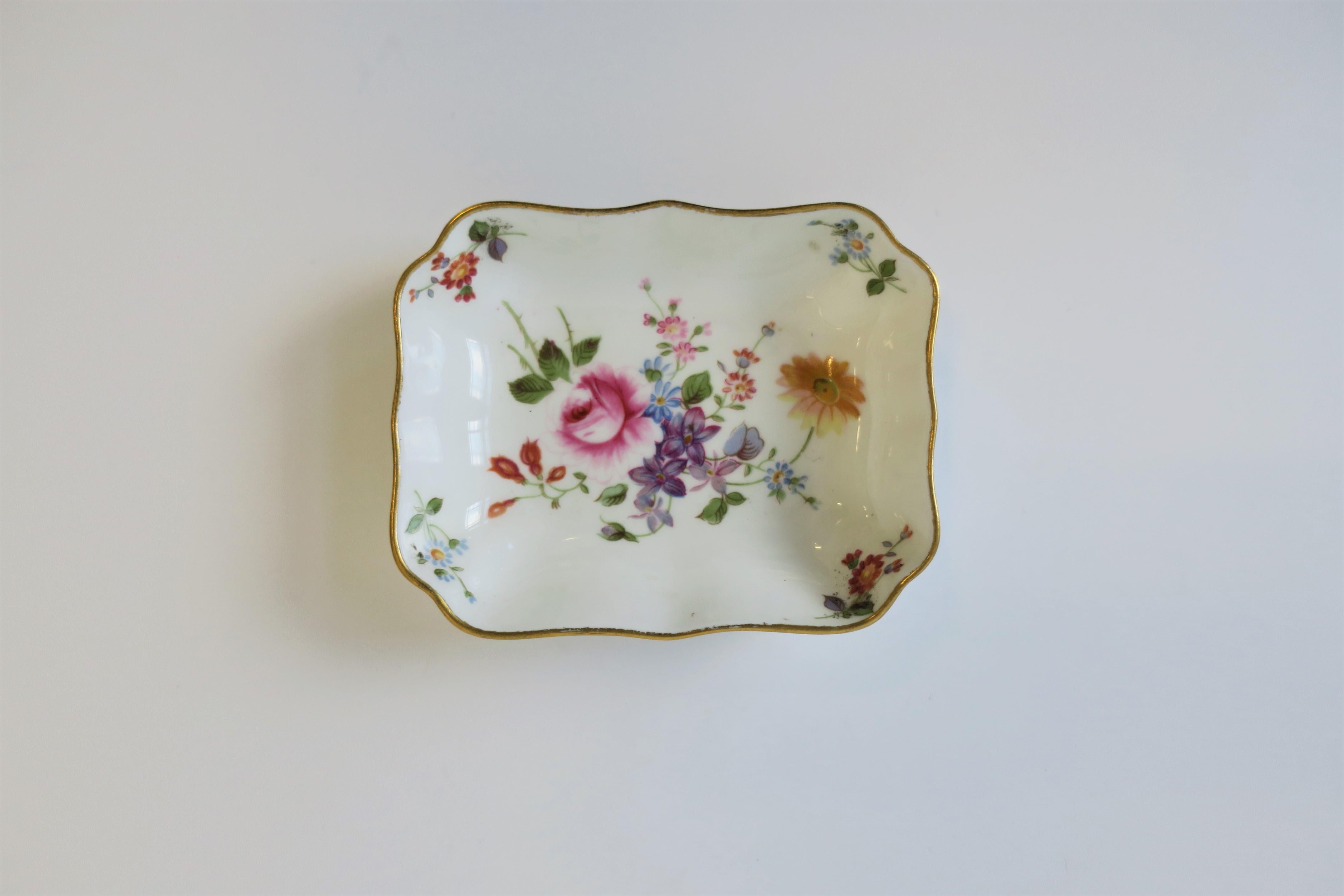 An English white porcelain jewelry dish by Royal Crown Derby with colorful floral 'chintz' design, circa 20th century, England. Great for a vanity, nightstand, bedside, etc. 

Dimensions: 3