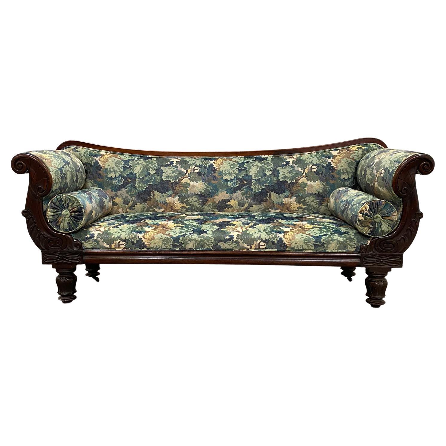 This superb William IV sofa is of fine quality and elegant form. It comprises of a mahogany frame and features an elegant shaped top rail, Egyptian revival arms and laurel leaf carved legs. 
The sofa is recently reupholstered in a stunning oak leaf