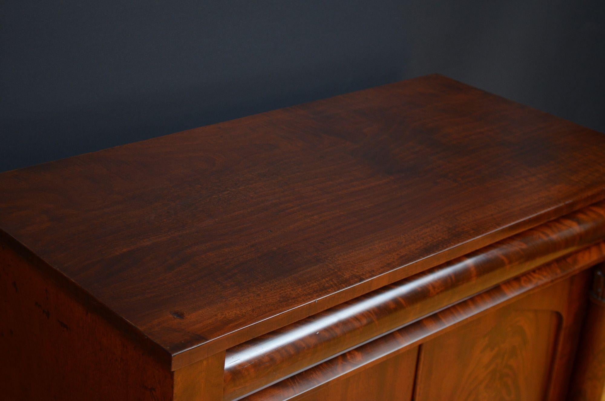 St056 Fine quality and very attractive William IV mahogany sideboard, having figure mahogany top above cylindrical drawer and a pair of panelled flamed mahogany doors fitted with working lock and a key and enclosing a shelf, all flanked by columns