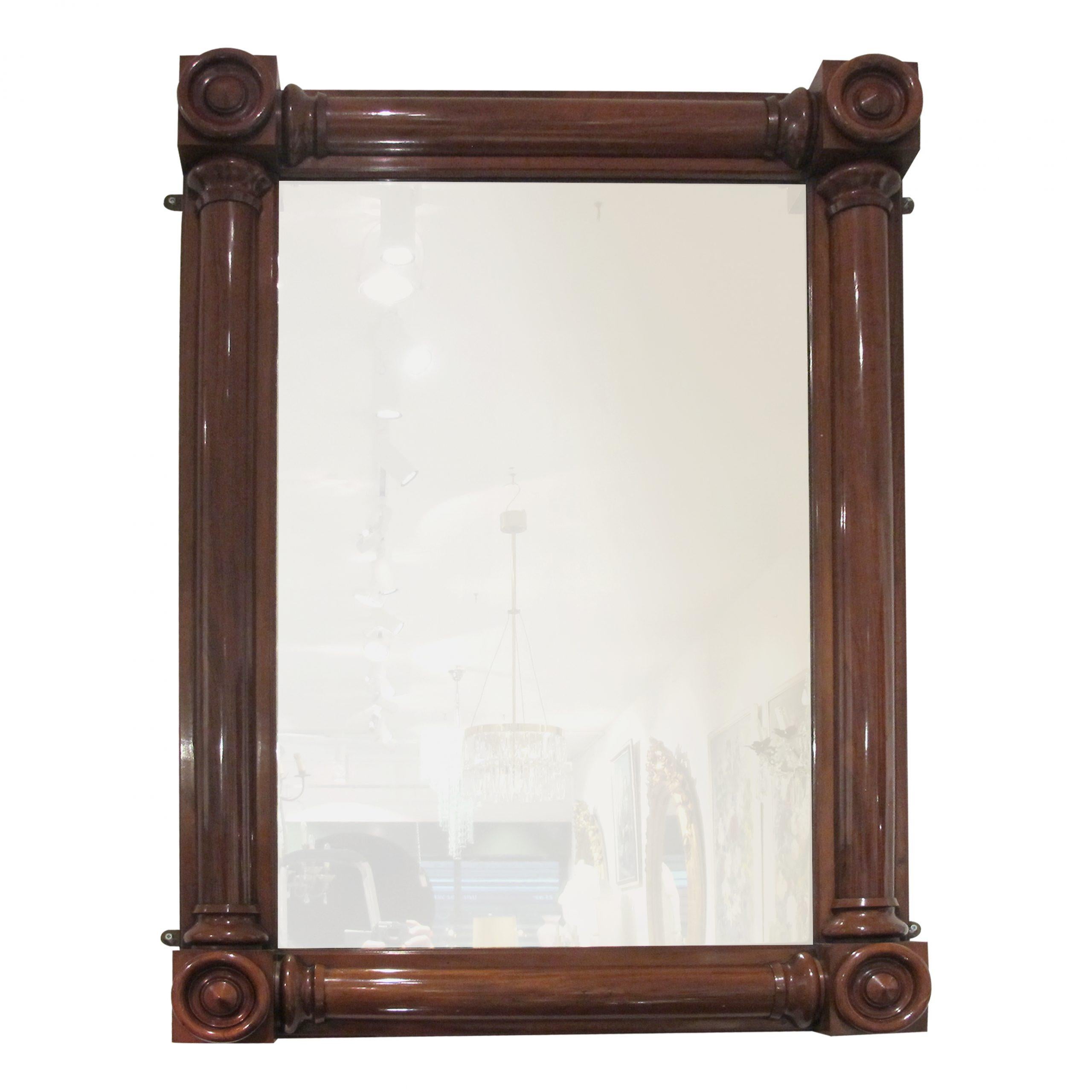 This is a majestic structural mahogany William the IV mirror, 1830s. The symmetry of the mirror allows it to stand alone, over a mantel or in a landscape position. The original glass shows barely noticeable signs of foxing adding character to the