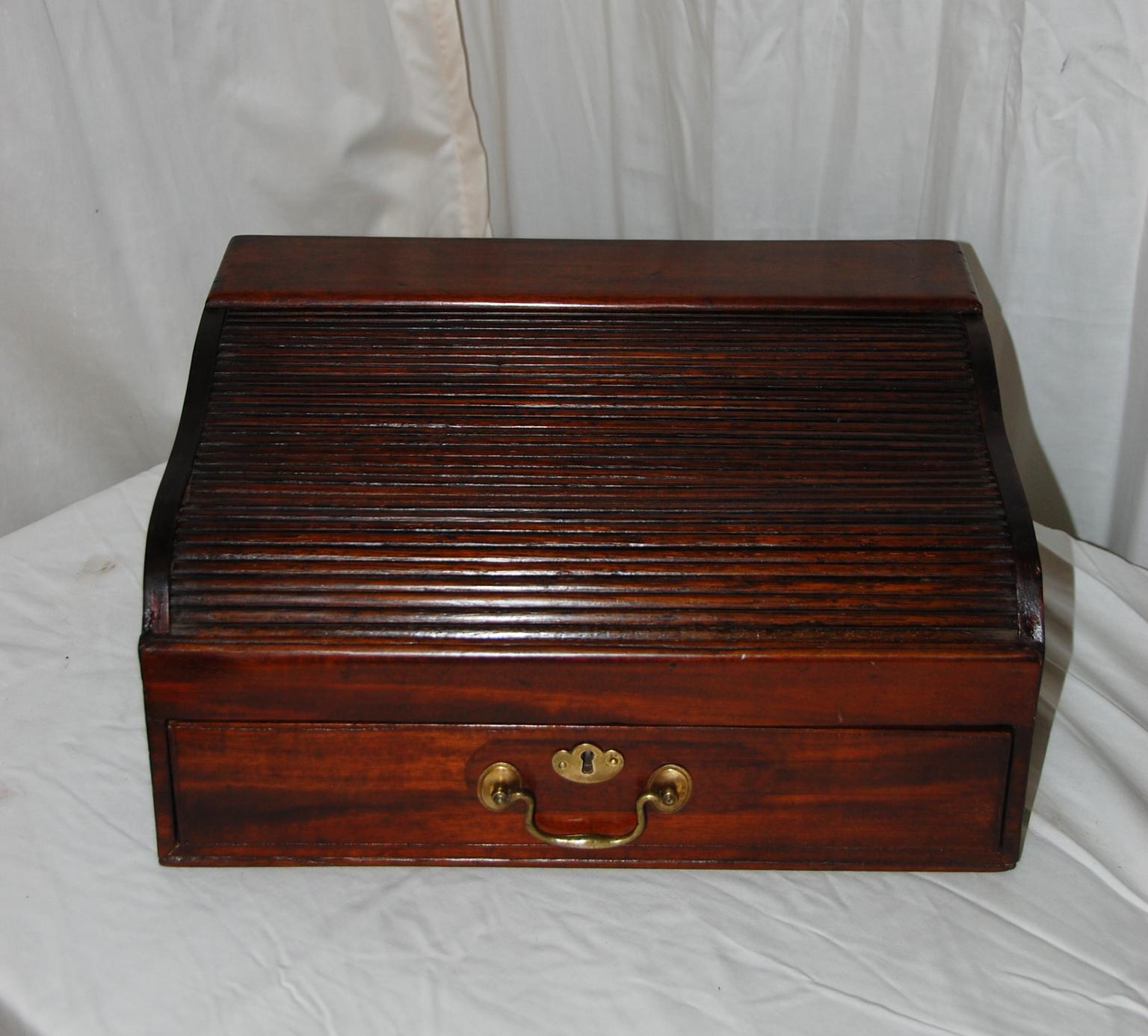 English William IV mahogany tambour writing box with drawer.  The tambour top is serpentine in shape, rolls back and reveals a place for writing utensils and ink (a removable open narrow box is ideal for pens or ink bottles).  There is a separate
