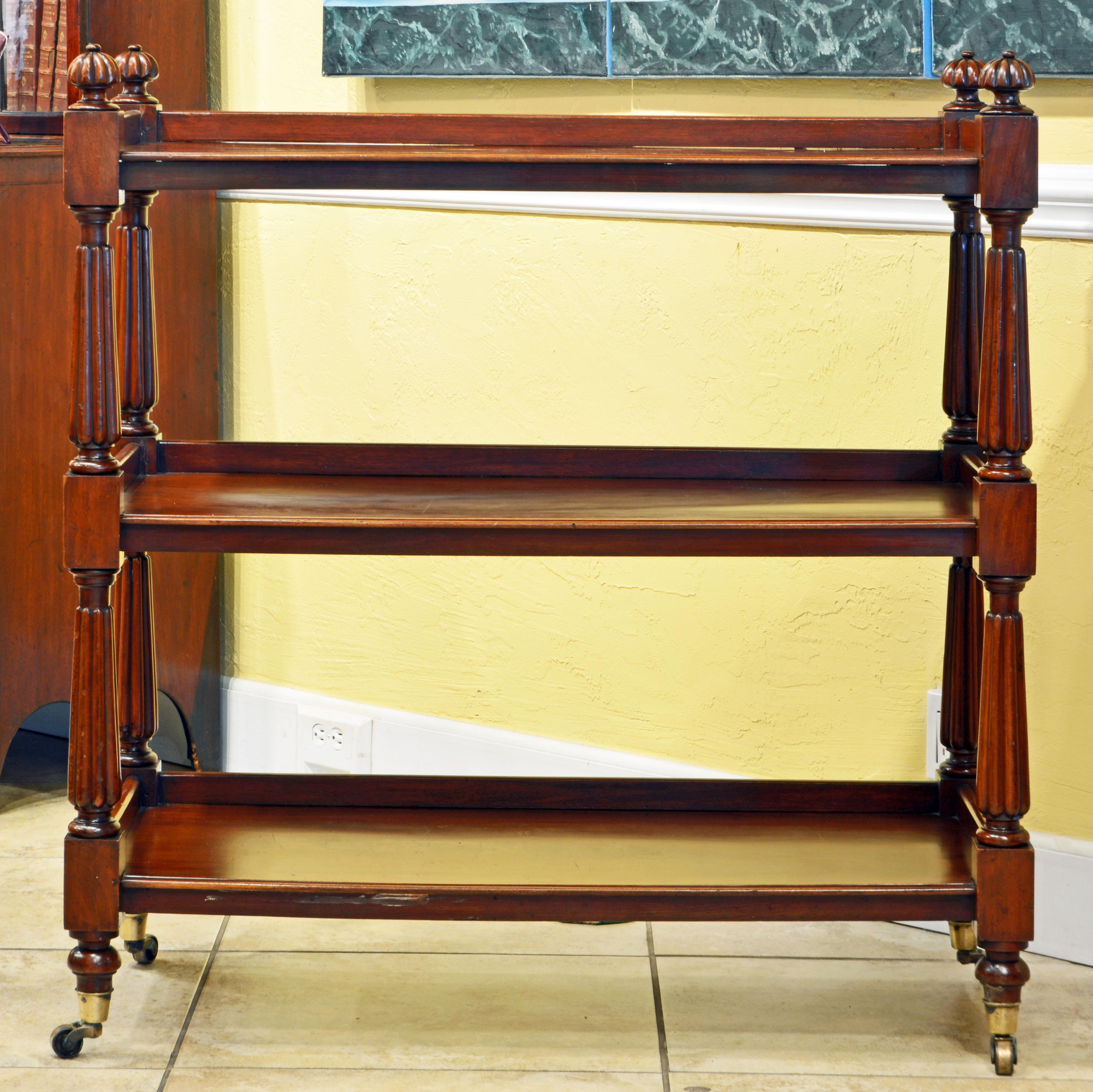 This fine William IV mahogany trolley features three edged tiers supported by four turned and carved legs surmounted by carved rosettes and resting on brass castors. The mahogany is of prime quality with a warm polished patina. Note that also the