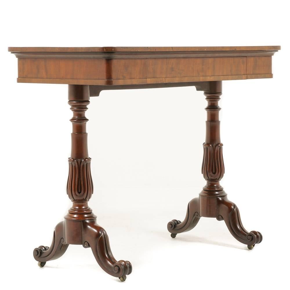 A small, English, William IV writing table in nicely-figured mahogany, having a well-carved double pedestal base and a single drawer fitted to the frieze, circa 1835.


 