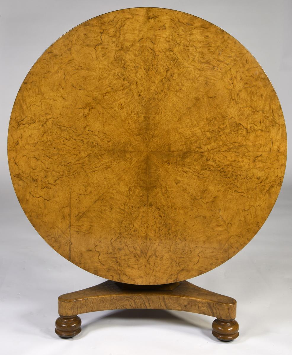Antique English William IV pollard oak tilt-top circular center table with pie-shaped segmented top, concave triangular pillar support, platform base, and turned feet with castors. Wonderful color and waxy finish,
circa 1835.
   