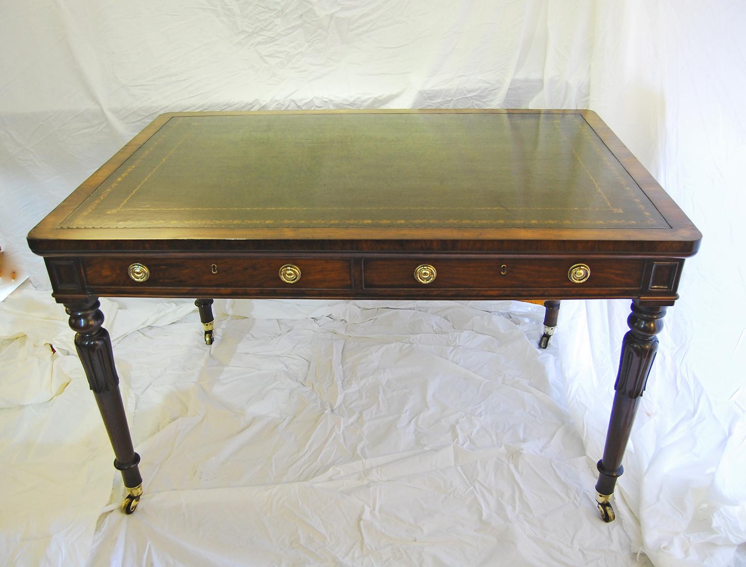   English William IV rosewood writing table with replaced hand tooled and hand dyed antique green leather.  This writing table is nicely detailed using high quality timber and a fine craftsman did the carving on the legs    This desk can be free