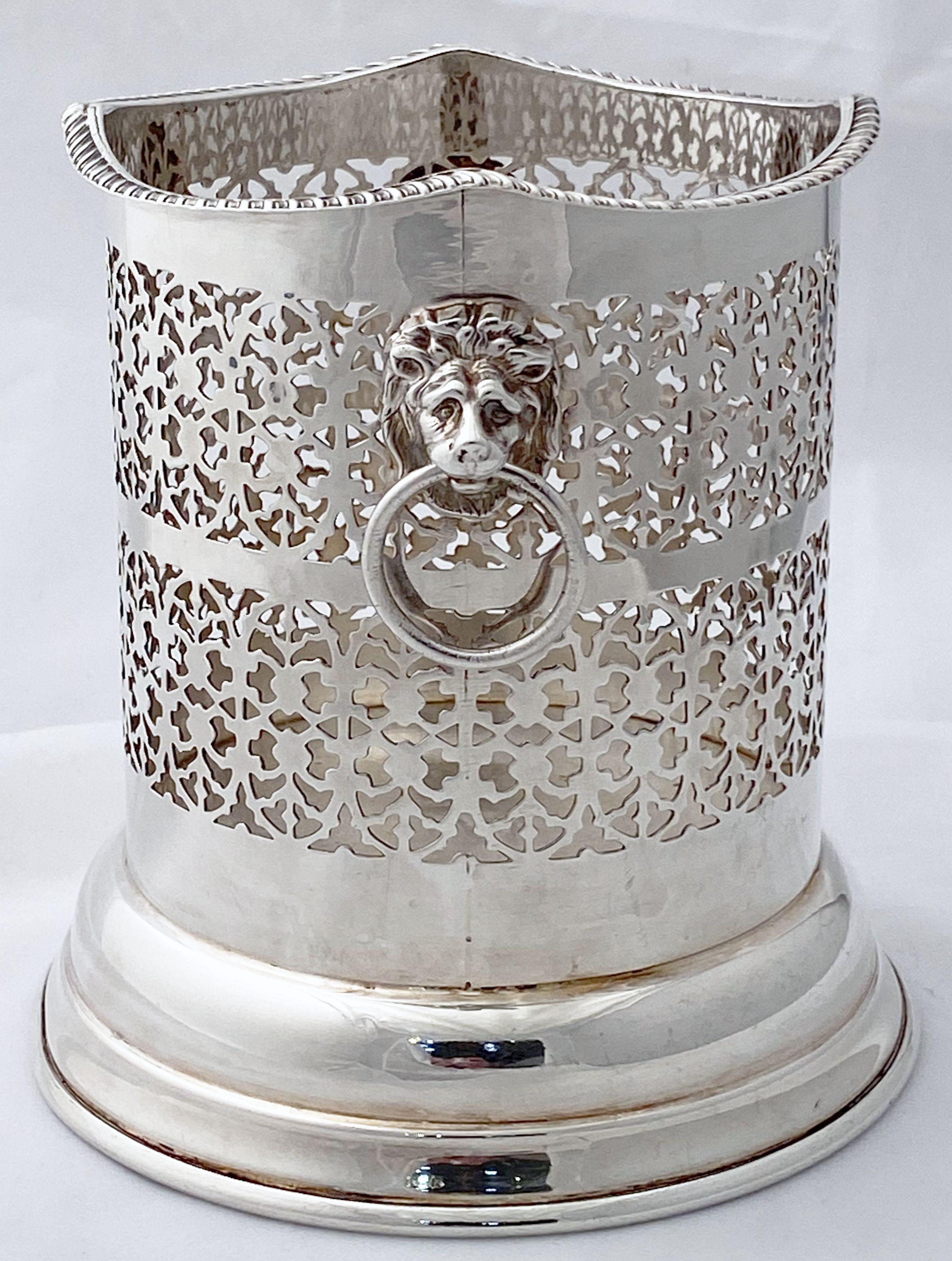 A handsome English wine bottle display holder or coaster of fine plate silver, featuring a pierced design around the circumference and opposing Regency lion ring pull handles, with serpentine edge around the top.

Designed to add a fine level of
