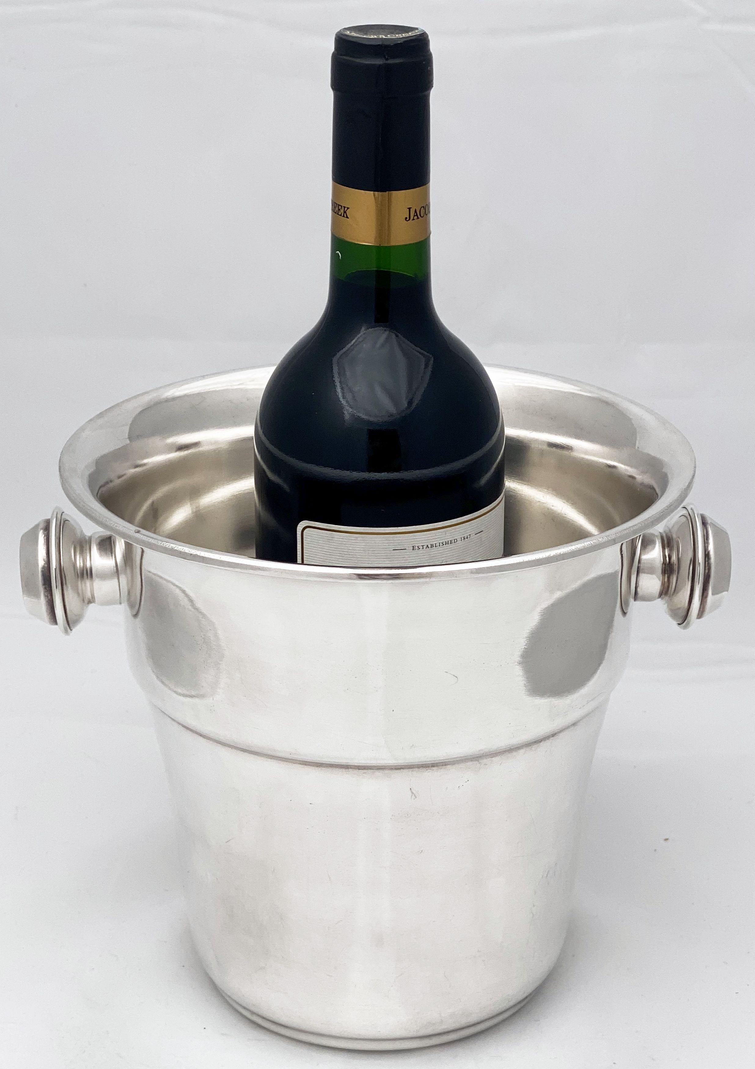 A handsome English wine bucket or champagne cooler of fine plate silver featuring a flared top edge and opposing handles.

Impressed mark - Cornet on base.