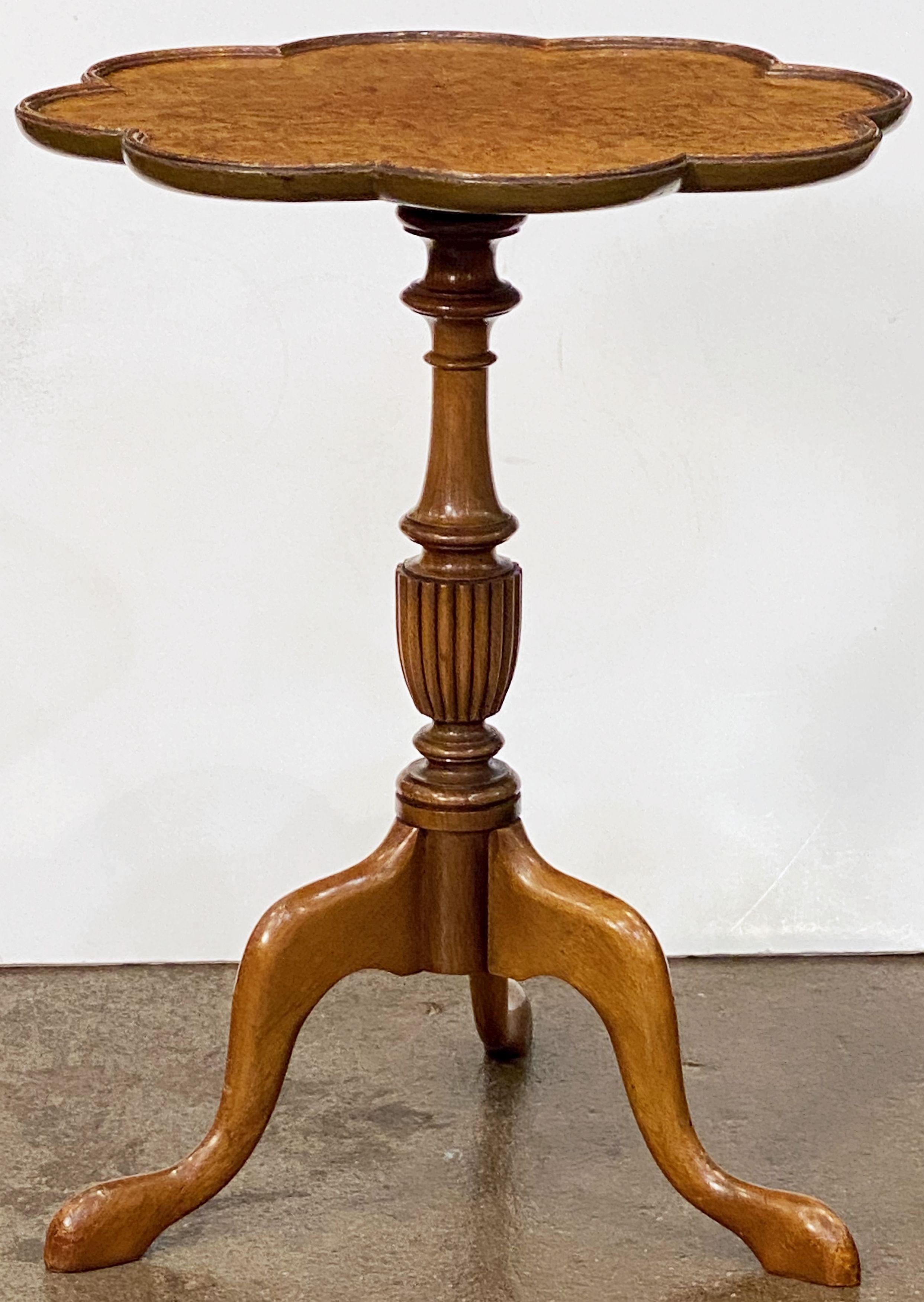 A fine English wine or cocktail table of burled walnut - featuring a raised edge around the circumference of the scalloped, moulded top, mounted upon a turned column pedestal with tripod base.

An excellent choice as a side table or for serving.