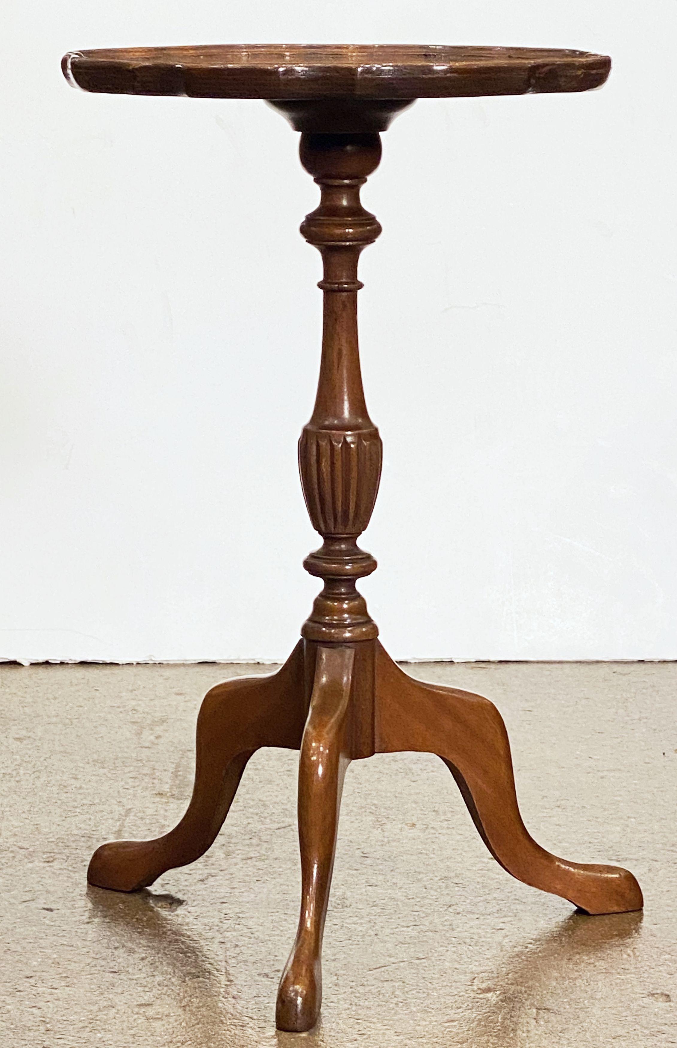 An English wine table of burled walnut, featuring a raised edge around the circumference of the scalloped top, mounted upon a turned column pedestal with tripod base.

An excellent choice as a side table or for serving.

Table Top diameter: 12
