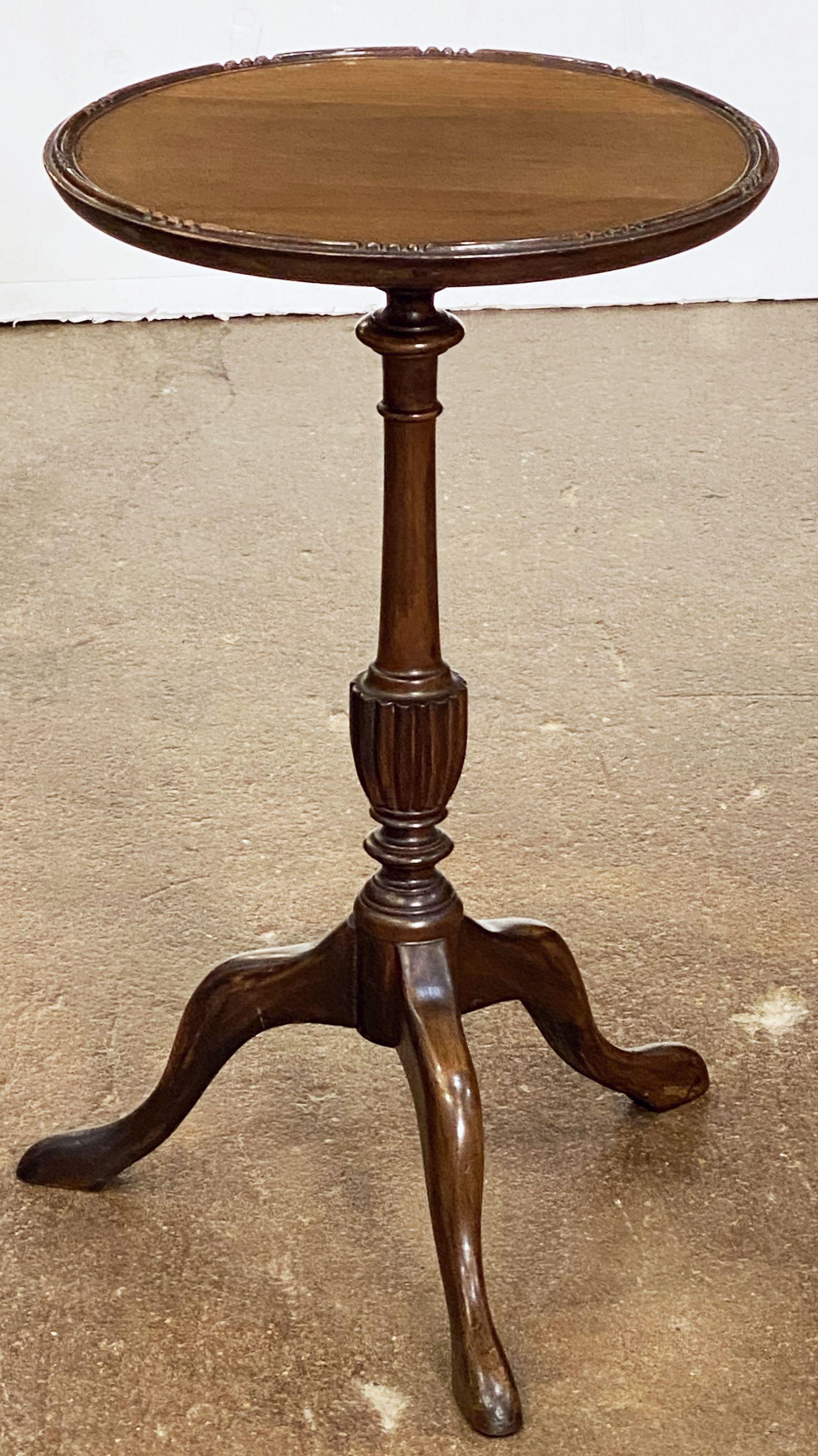 An English wine table of mahogany featuring a raised edge around the circumference of the round, moulded top, mounted upon a turned column pedestal with tripod base.

An excellent choice as a side table or for serving.

 