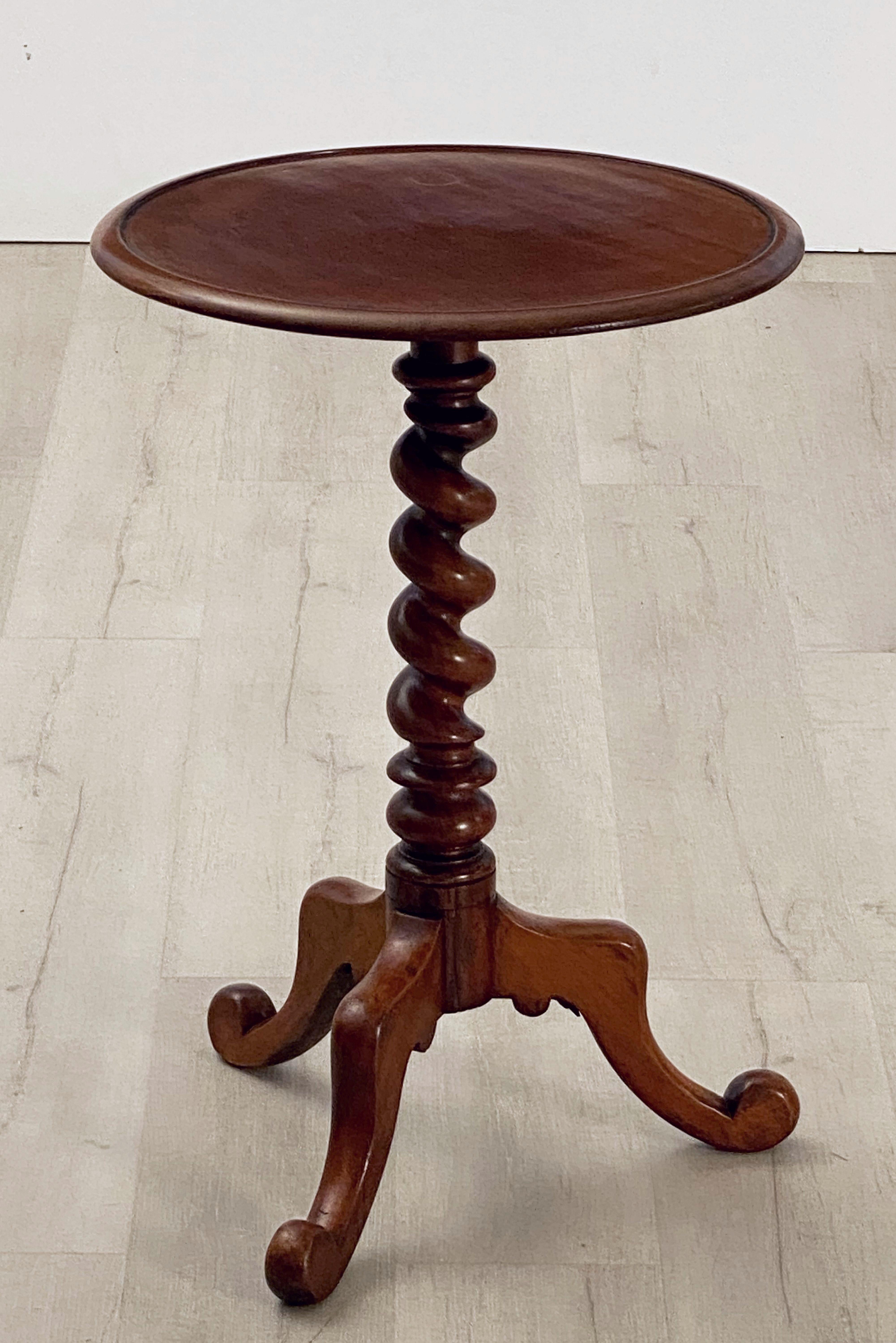 A fine English wine or drinks table of mahogany, featuring a round or circular top over barley twist stem or column with tripod legs.

Makes a great occasional or side table for a chair or sofa.
  