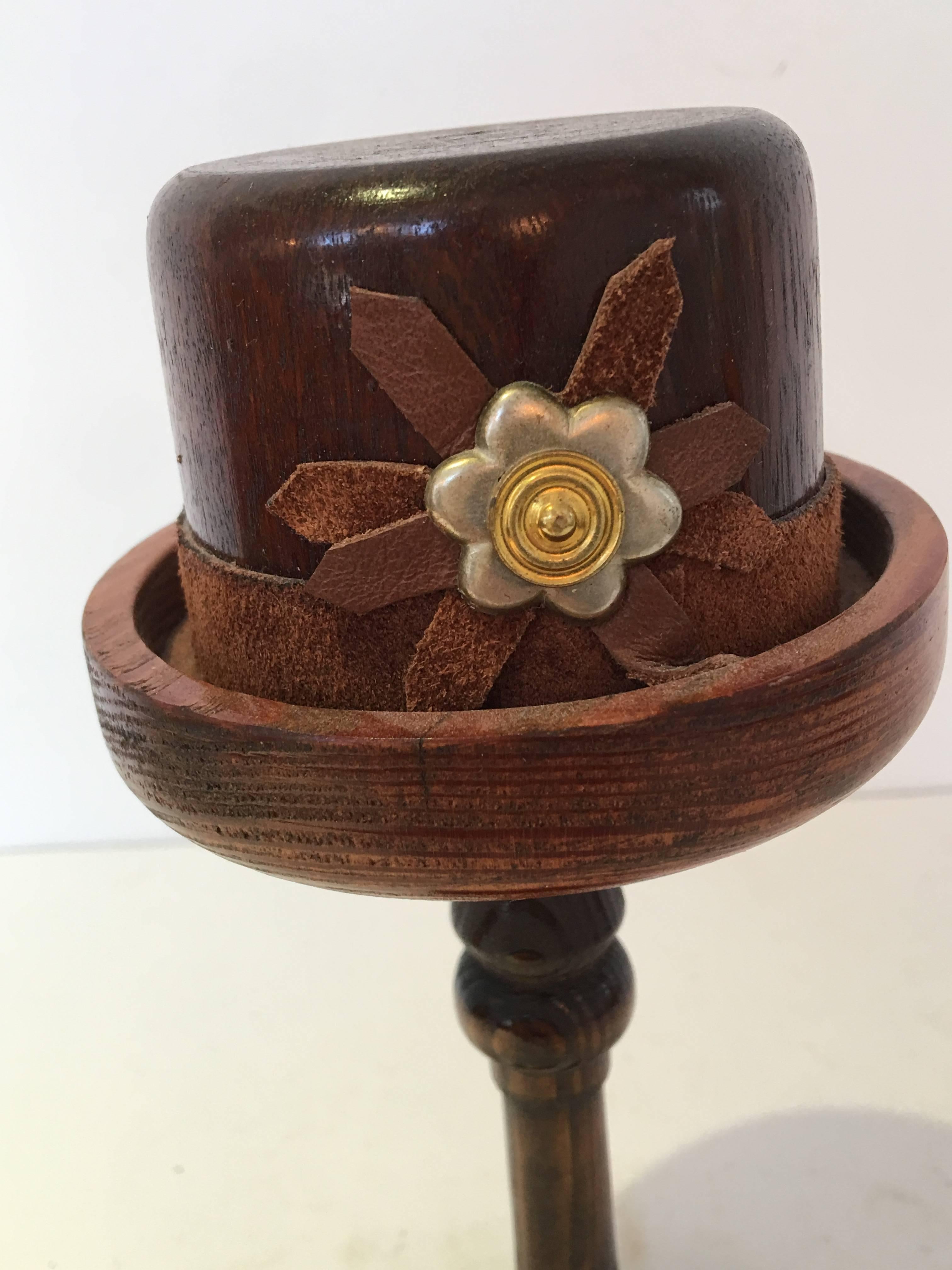 English wood doll hat mold on wood stand
circa 1920s-1940s #793/ 8276
Top hat with metal and leather flower detail and leather ribbon.