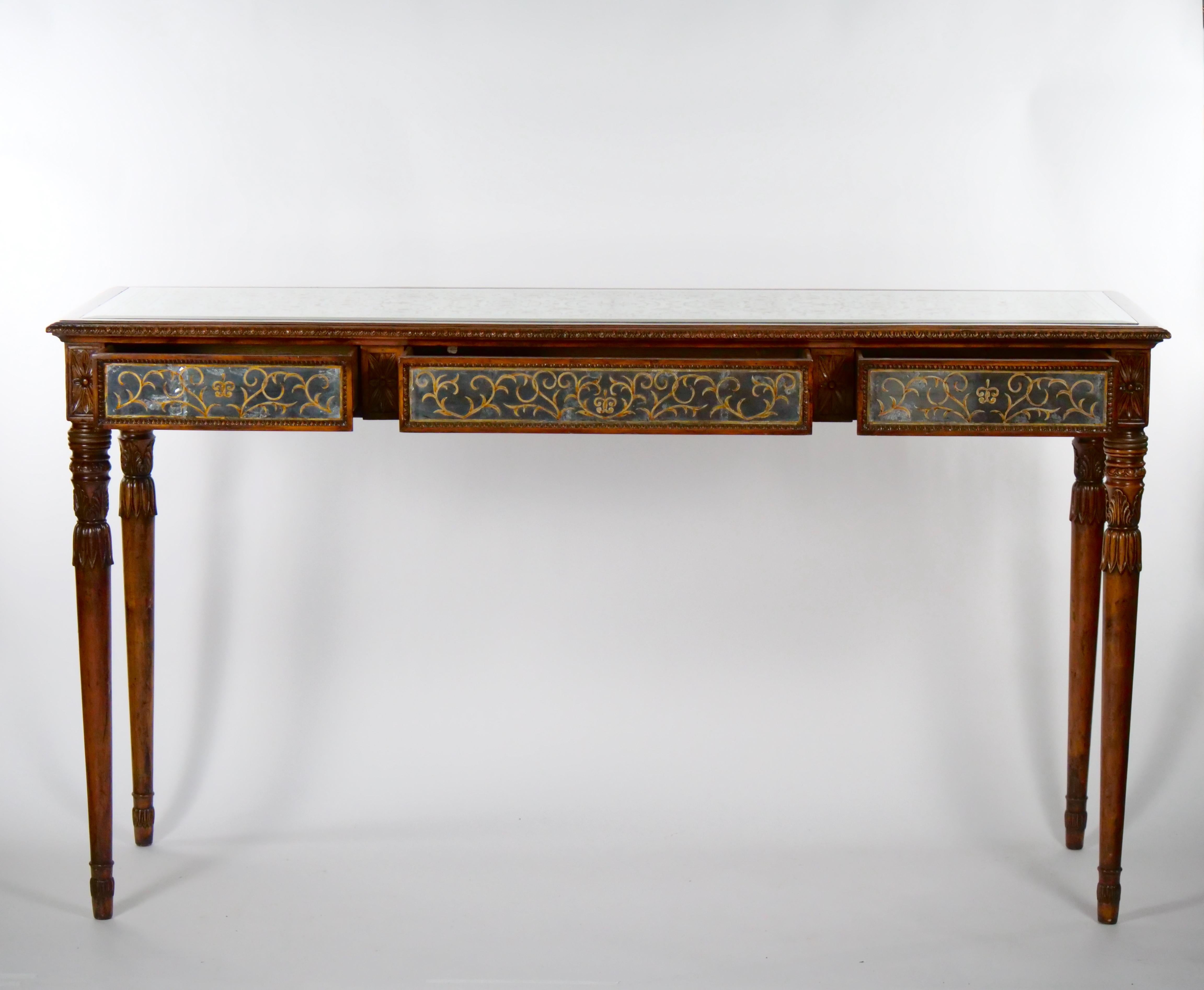 Beautifully hand carved mahogany wood framed hand etched decoration mirrored console / sofa table. The console table features an hand etched mirrored top decoration , three front pull drawers resting on four hand carved fluted legs. The table is