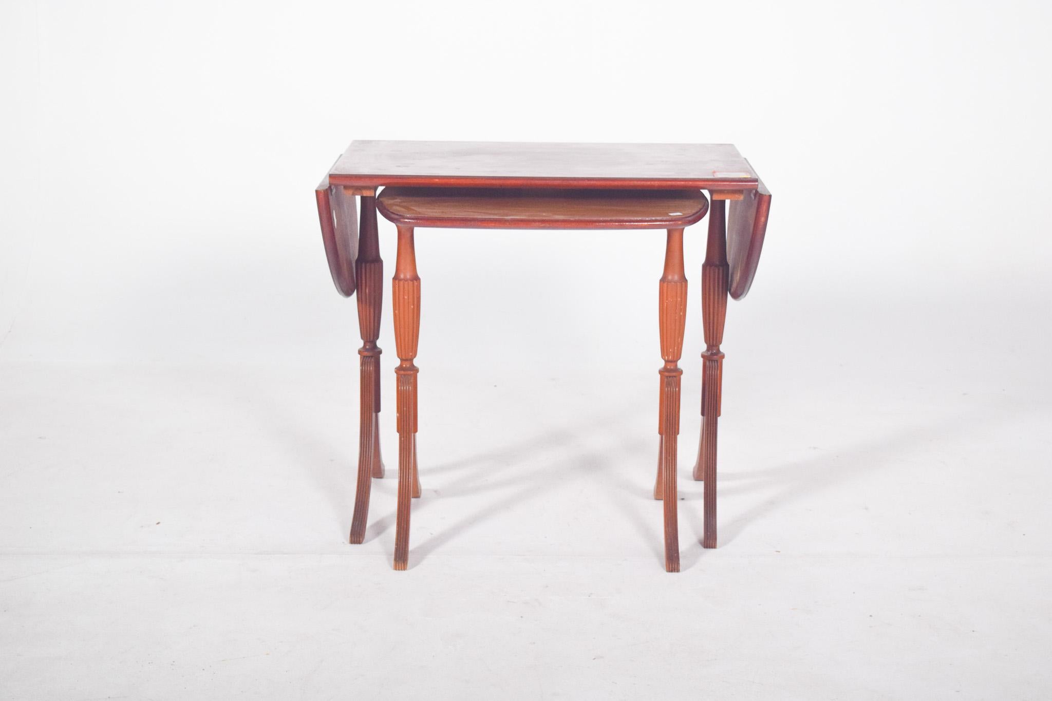 English mother tables. The larger table has an extendable top with semicircular side wings that can be folded or raised as needed. The smaller one fits perfectly under the frame of the larger one, making it easy to store and save space when not in