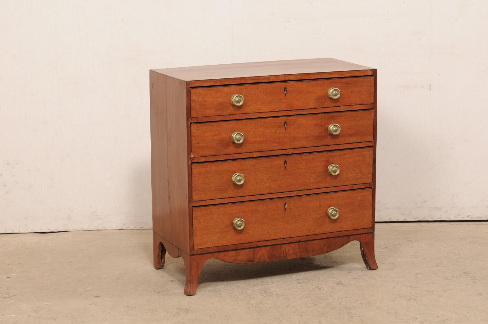 An English chest of four drawers from the early to mid 19th century. This antique chest from England features a rectangular-shaped top with a case which houses four graduated drawers, and has a lovely swag carved skirting along front and both sides.