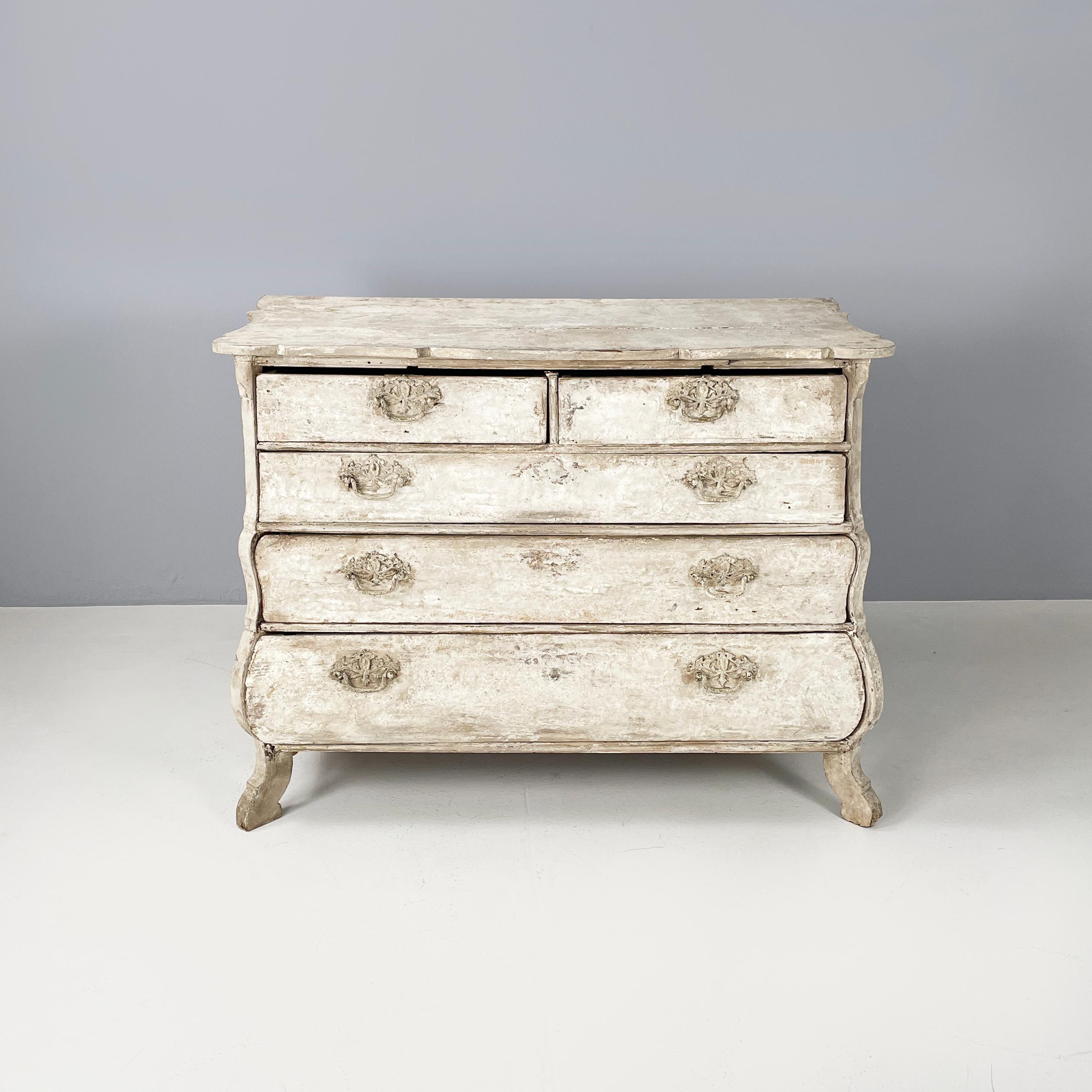 English Wooden chest of drawers with not-uniform white finish, 1700s
Wooden chest of drawers with a not-uniform white finish. The cantilevered top has a shaped profile. The front has a slight curvature. There are 2 small and 3 large drawers with