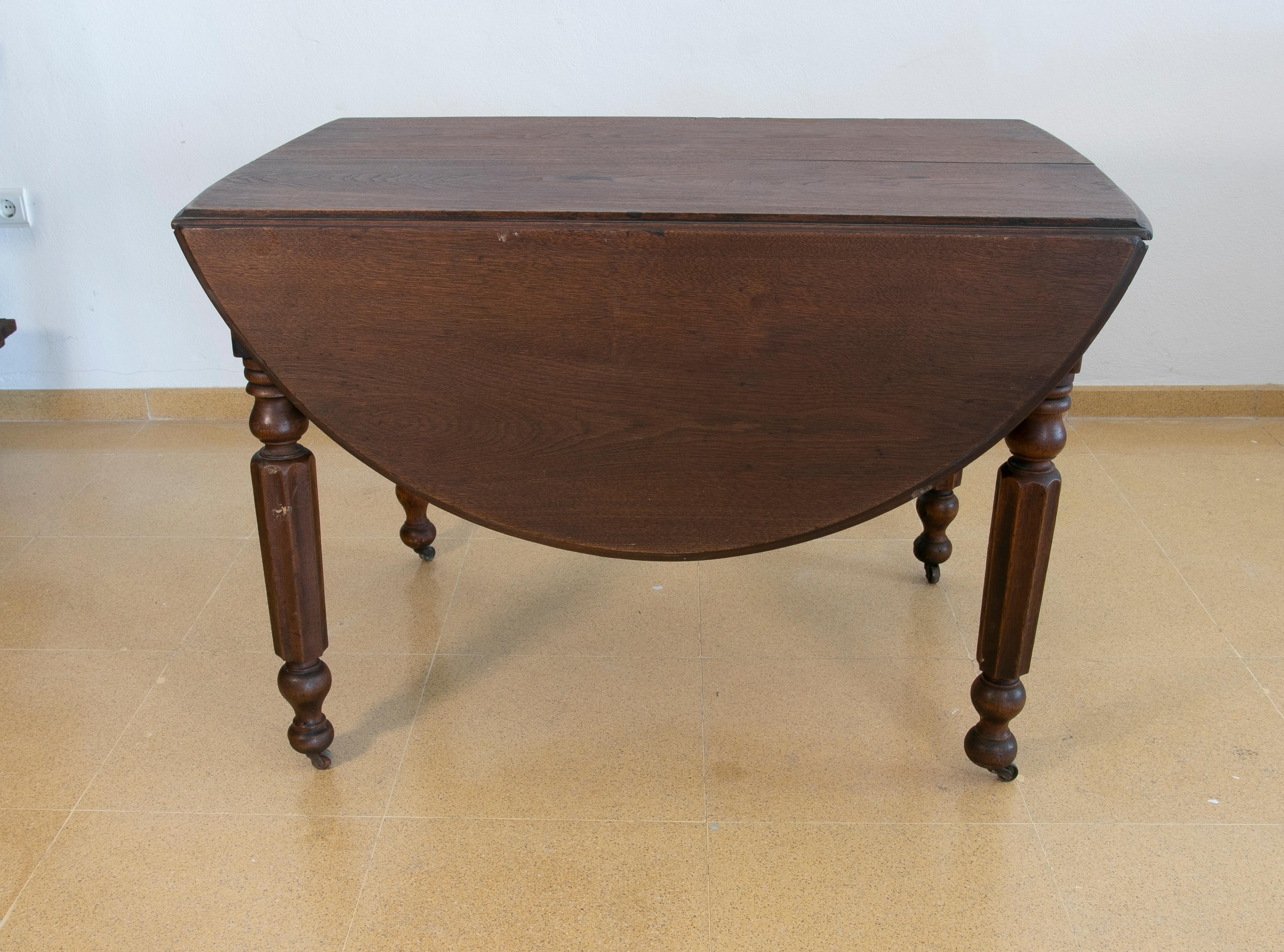 English wooden wing table with brass wheels.