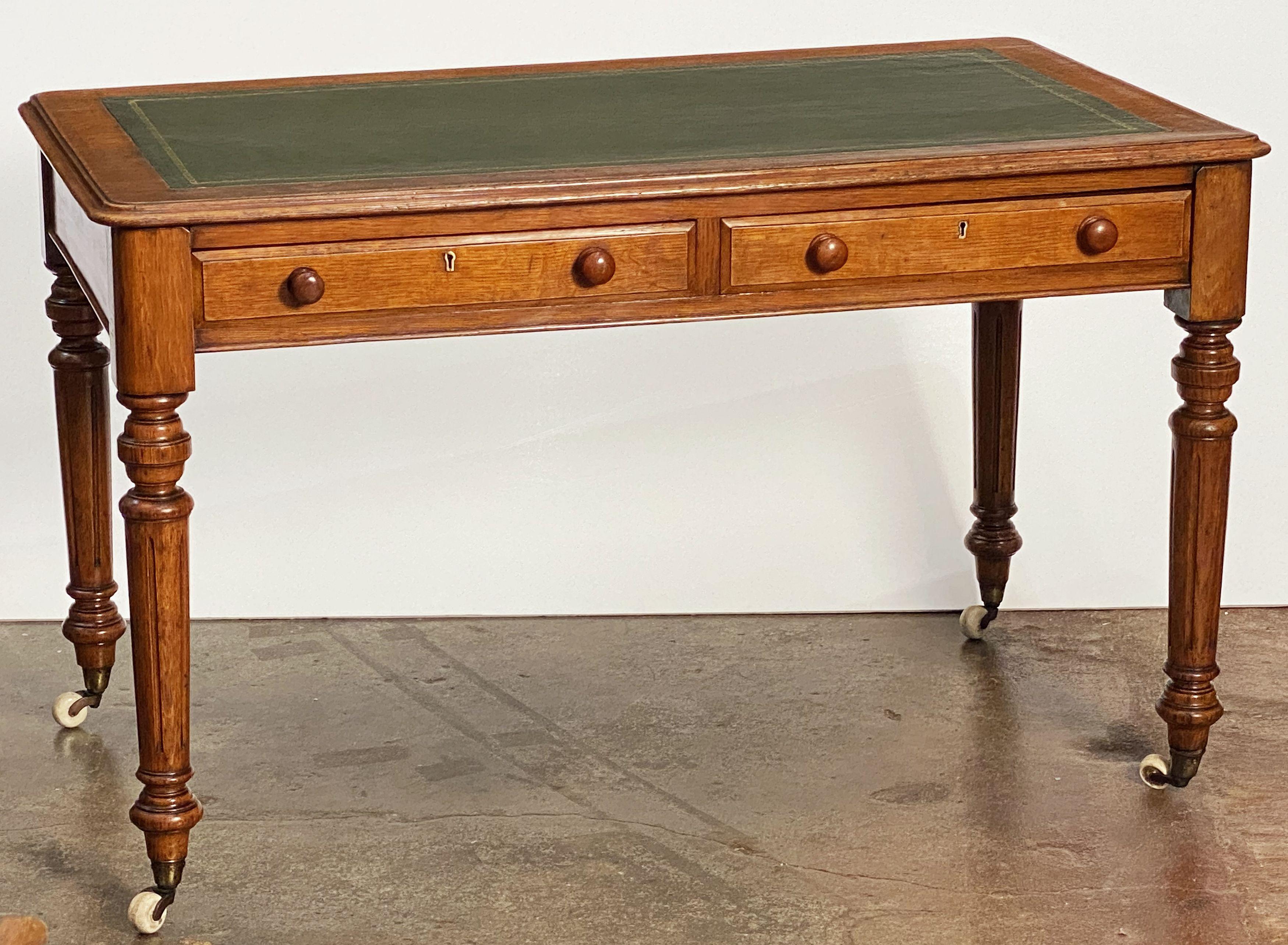 A handsome English writing desk or table of oak, circa 1880, attributed to the celebrated cabinetmakers, Gillows. 

Featuring an embossed leather top with an oak border and a moulded edge, over a frieze of two mahogany-lined drawers - each with