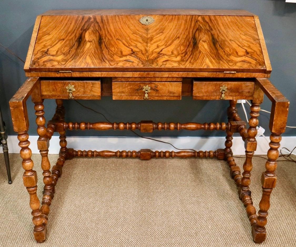 Magnificent 1930s writing desk with burl accents and in great condition. It features drawer both inside and out for ample storage. Great lines and better scale. Guaranteed to set any room apart. Made in England.