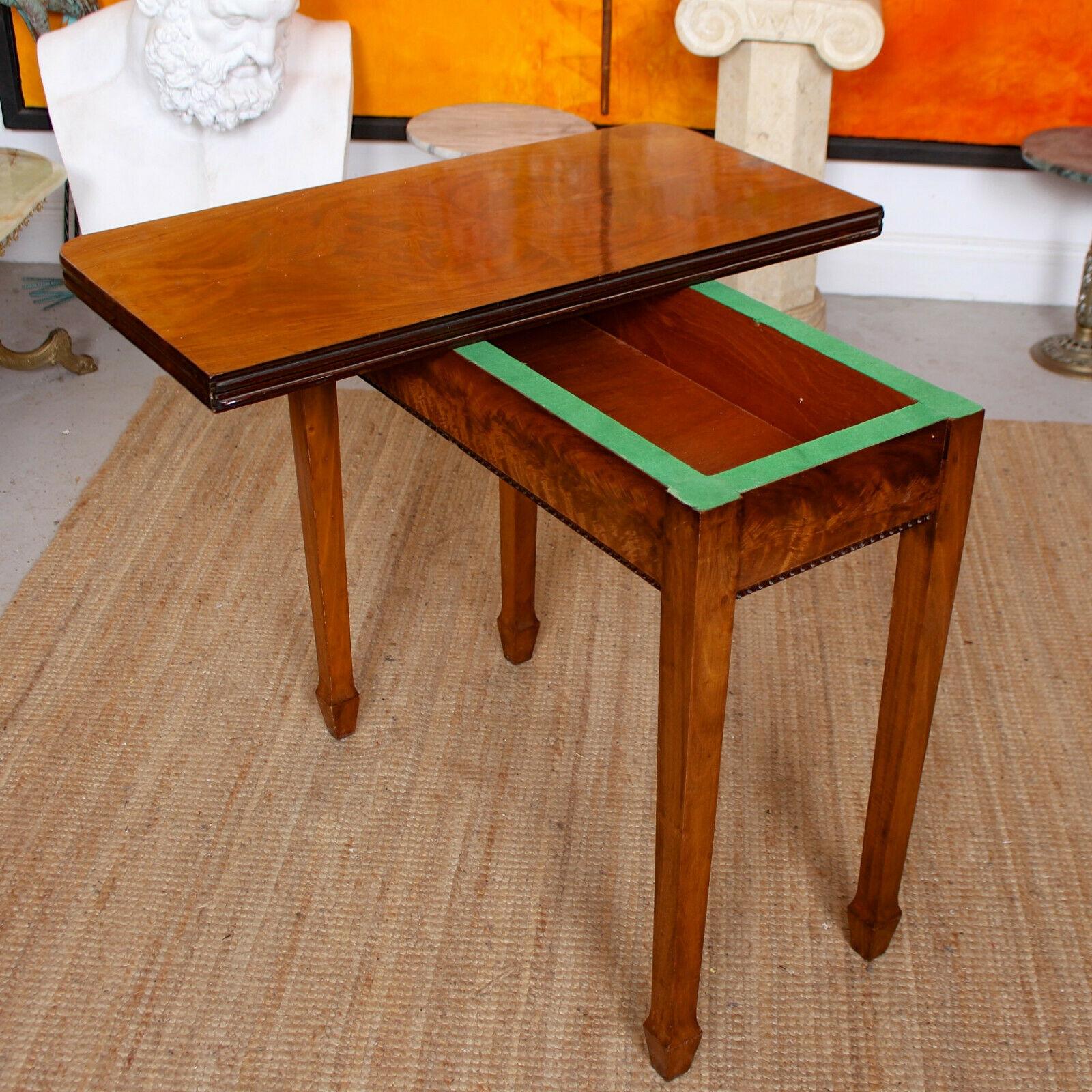 An impressive 19th century flamed mahogany foldover table.
The folding hinged top with rounded corners and enclosed a fine quality flamed mahogany boasting a well figured grain. The marquetry work apron with carved beaded detailed and raise don