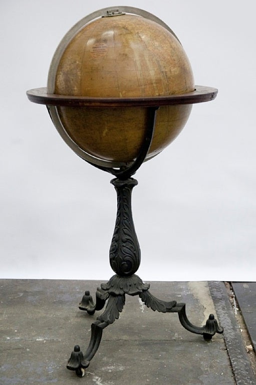 18 inches English paper mâché library terrestrial globe, wooden horizon circle, cast iron tripode with three wheels. W.& A.K Johnston to the Queen, 1890. Edinburgh & London.
