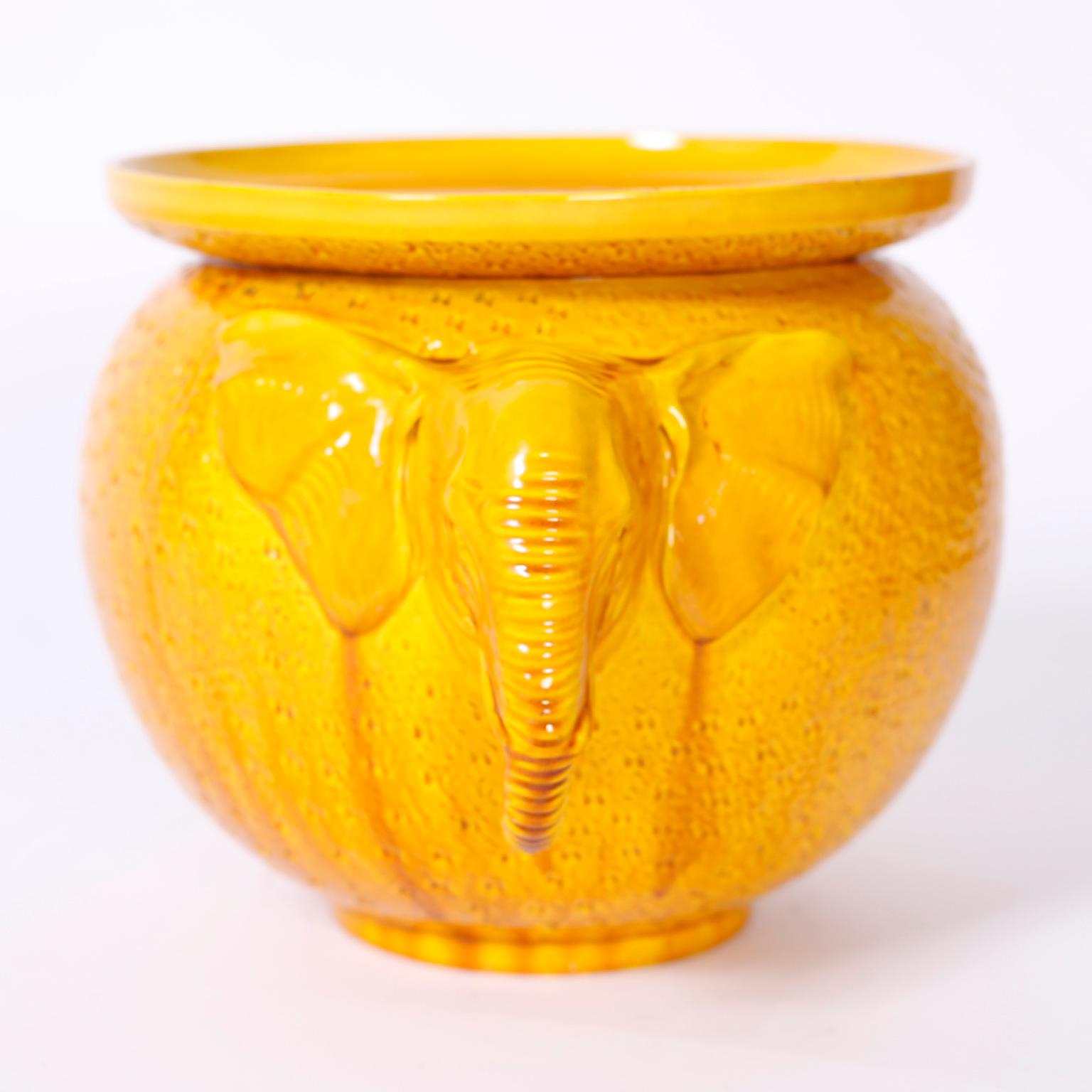 Striking Art Deco English porcelain jardiniere with an alluring yellow drip glaze over a Classic form with elephant head handles.