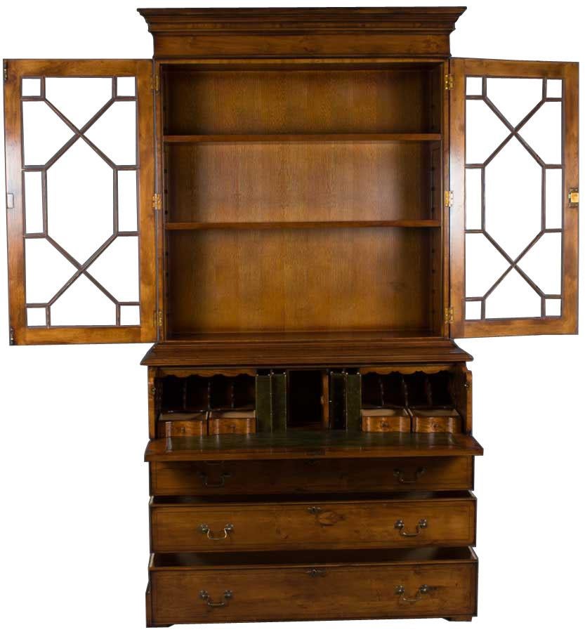 This yew secretary bookcase, also known as a bureau desk, is handmade in England as a Georgian period reproduction. Every aspect of this English-made secretary desk, from the techniques used to the materials themselves, is of the absolute highest