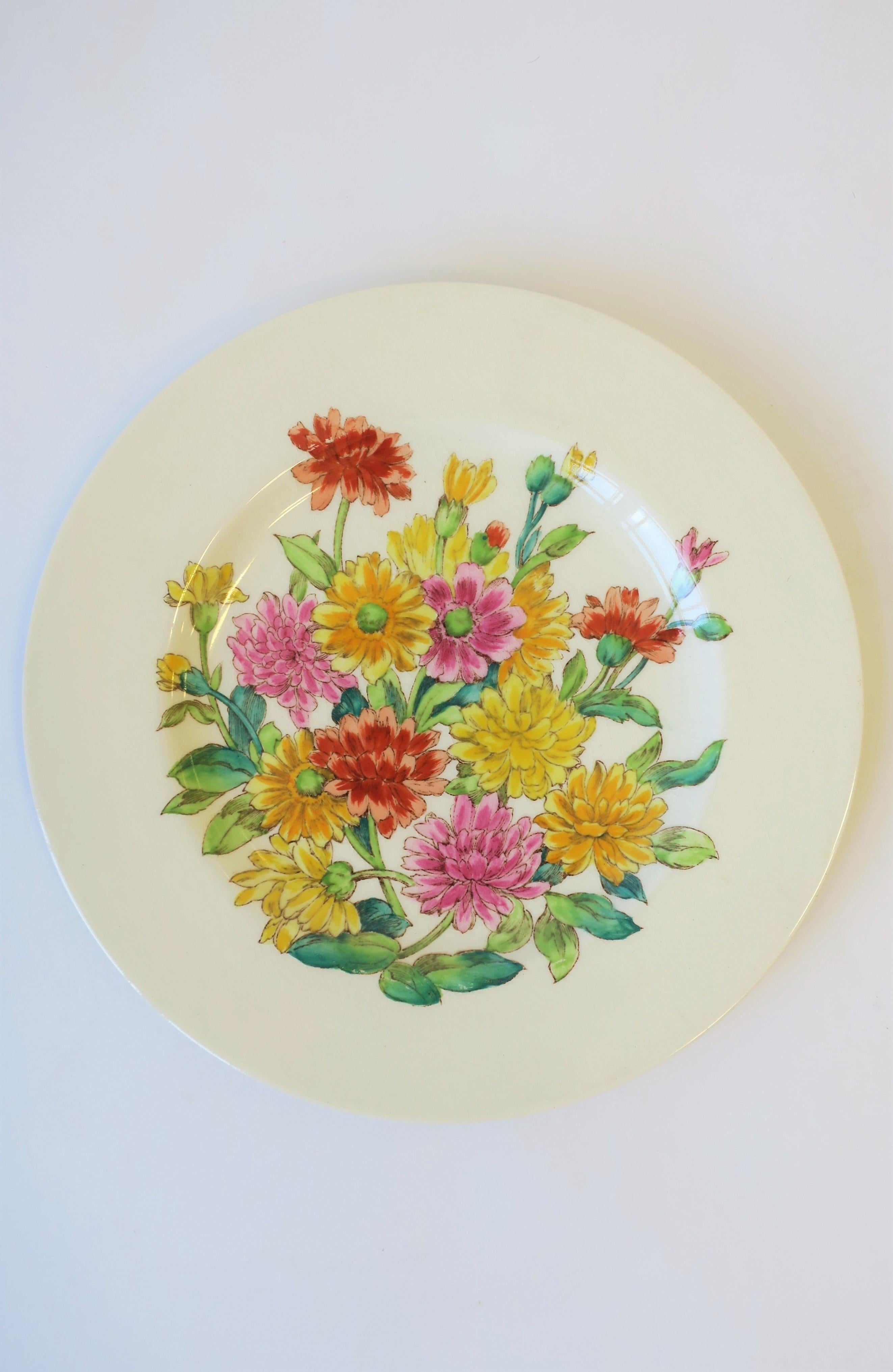 A beautiful English plate depicting Zinnia flowers, circa early-20th century, England. Flower colors include pink, red/orange, and yellow, with green leaves and vines. A beautiful plate for eating/entertaining or as wall art. Marked 