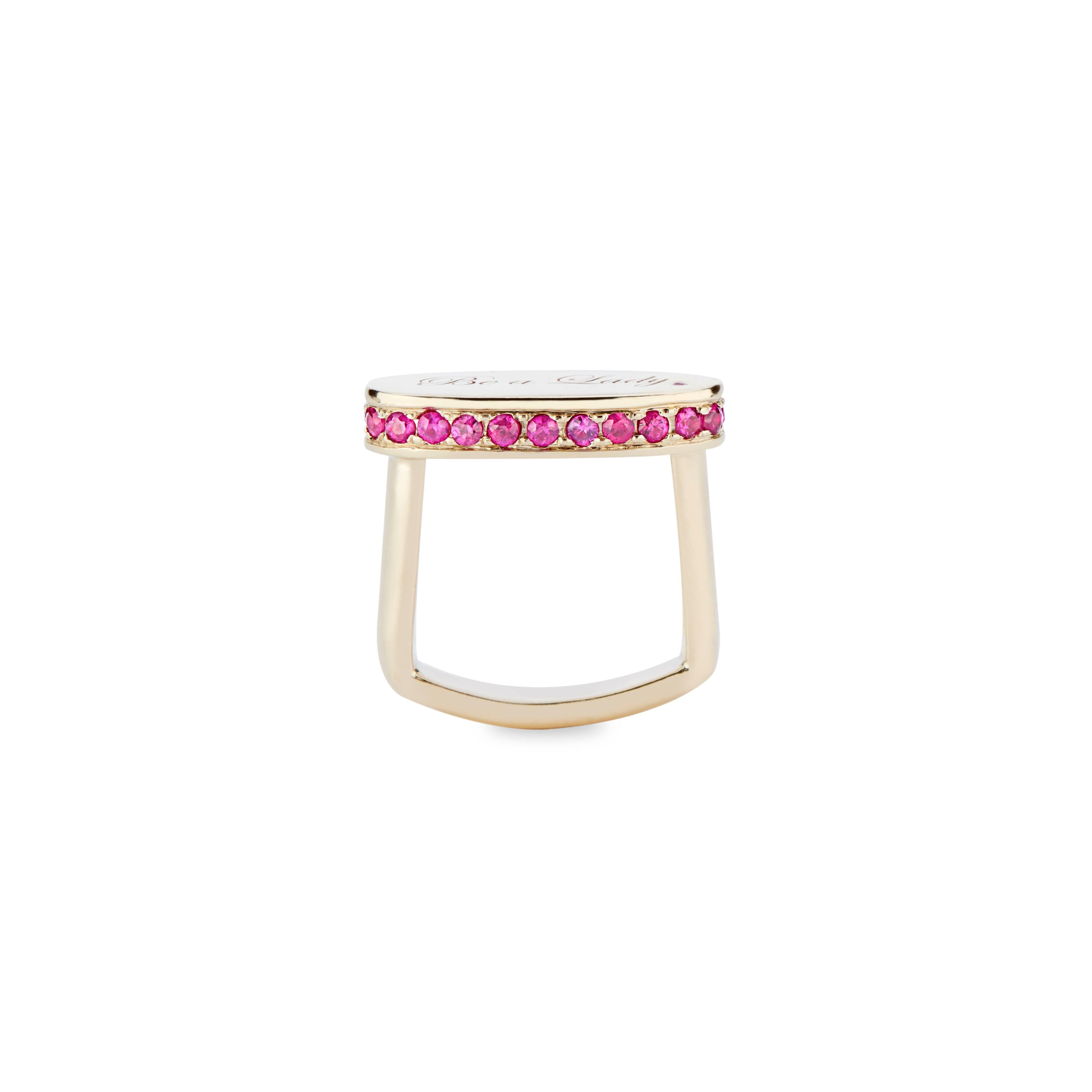 This 14k gold and pink sapphire signet engraved with 