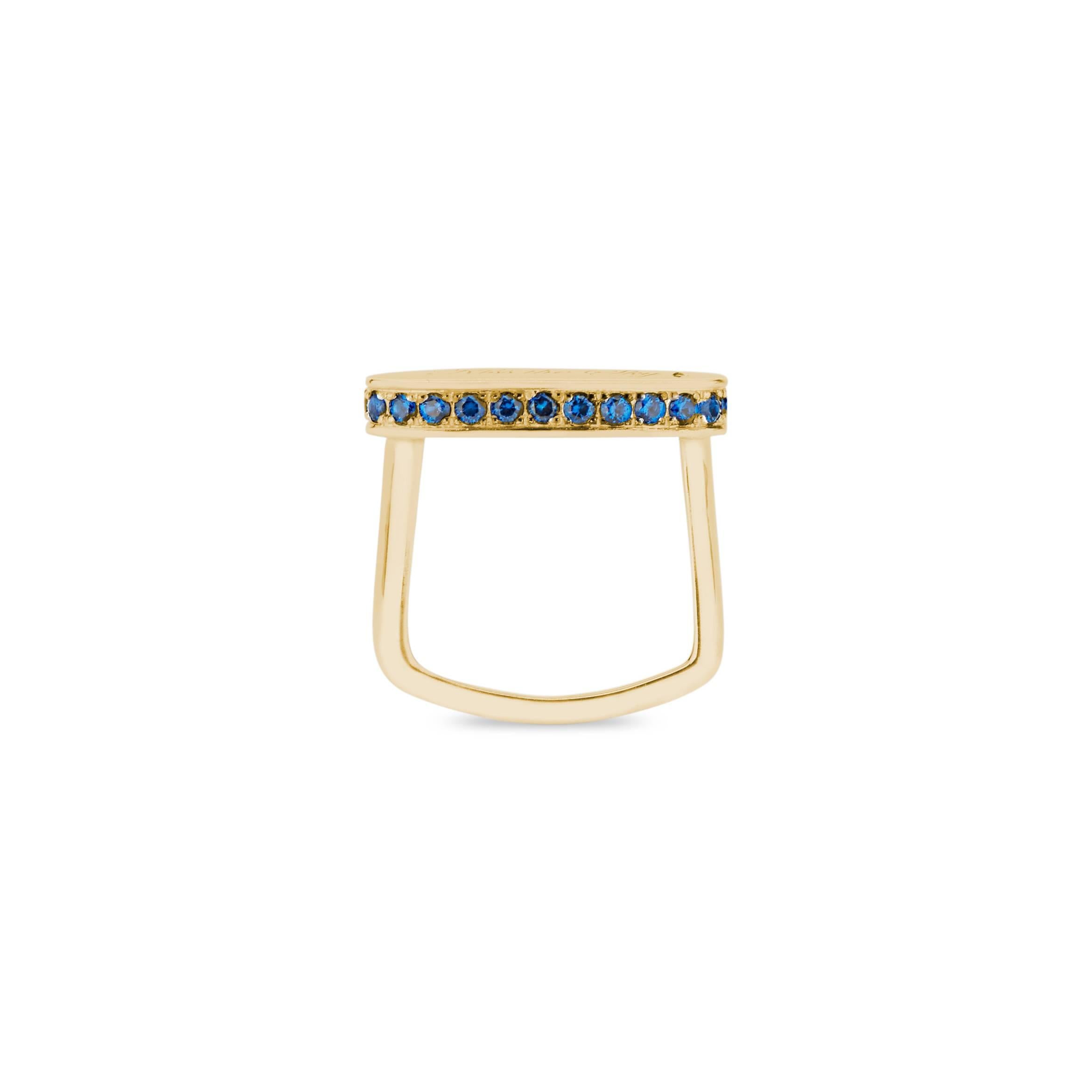 The 14k gold and blue sapphire signet ring is engraved with 