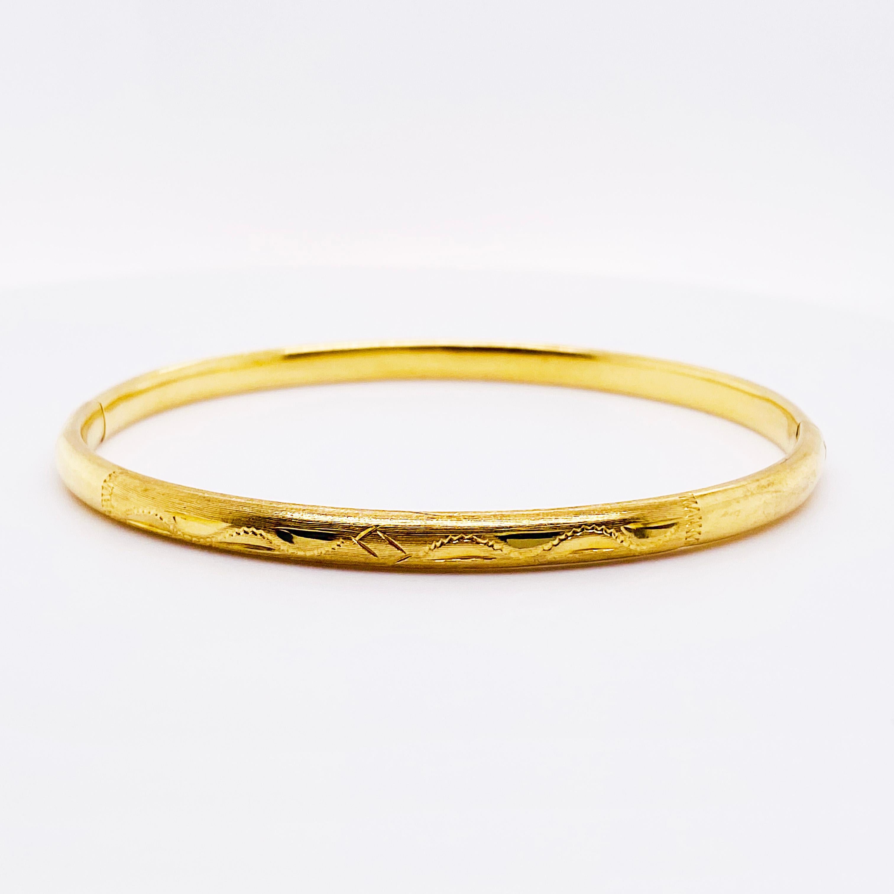 18K Yellow Gold Bangle Bracelet:  The 18kt bangle bracelet is 2.5 millimeters wide and has gorgeous hand-engraving on it.  The engraving has leaf and scroll design on it.  This bracelet is Circa 1970 so there is some wear on the engraving but it