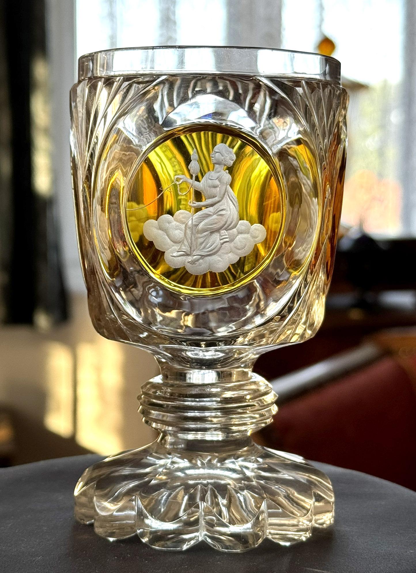 Unique engraved and cut goblet, Three cut medallions stained with amber lazure. The medallions depict three destinies, which symbolically represent the time of life that he holds in his hands. There is an old German inscription next to the fortune