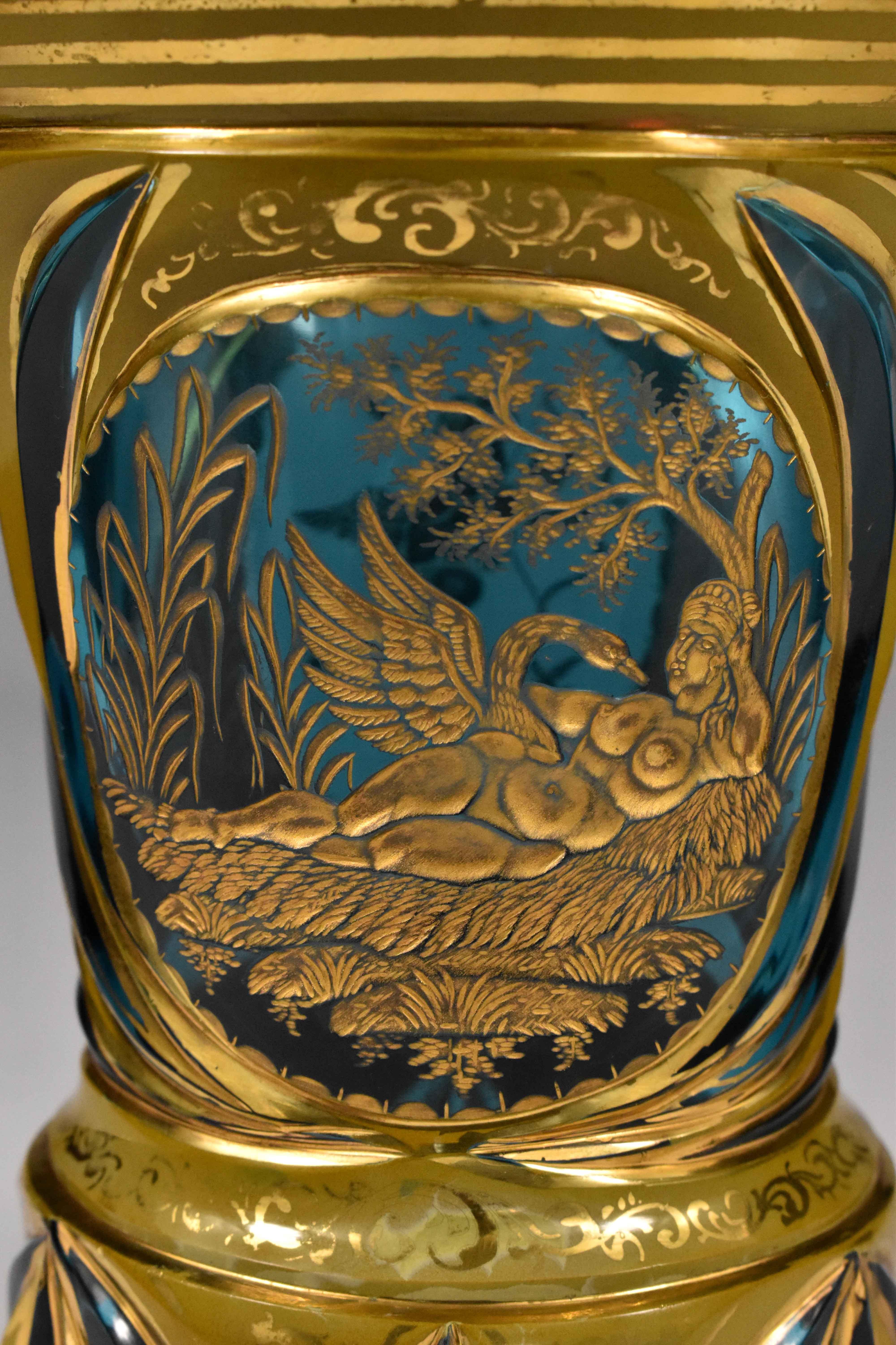 This beautifully cut goblet is made from aquamarine glass with particles of lithyaline. Gold mythology engraving in medallions. Leda and swan in one medallion and Cupid with a bow. Hand-painted with gold. F. Egermann 19th-20th century Bohemian glass
