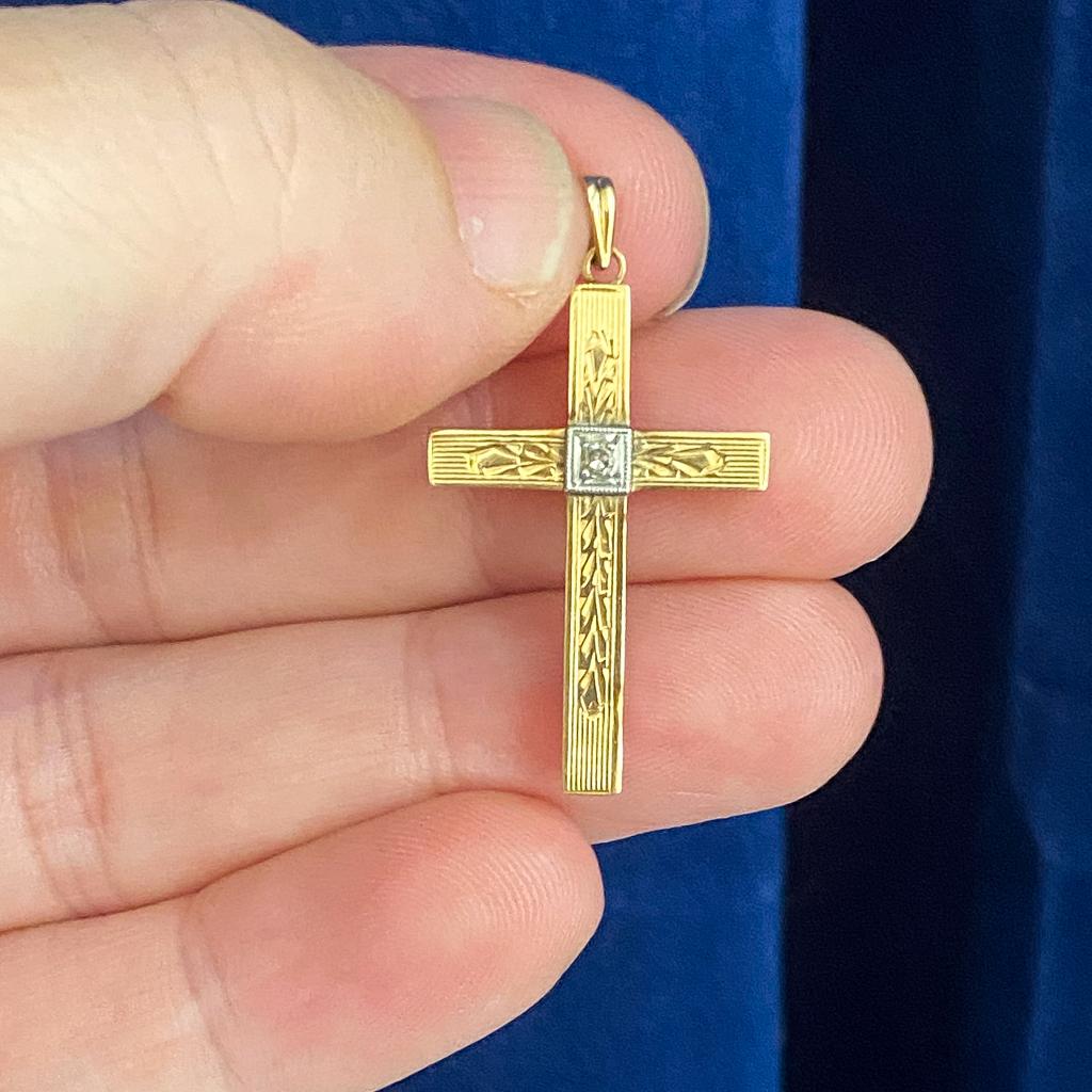 This intricately engraved cross is perfect for the person whose many intricacies you appreciate! A round diamond sits at the center of the cross, shining as bright as the spirit of your recipient, set in white gold and weighing 0.02 carats. This is
